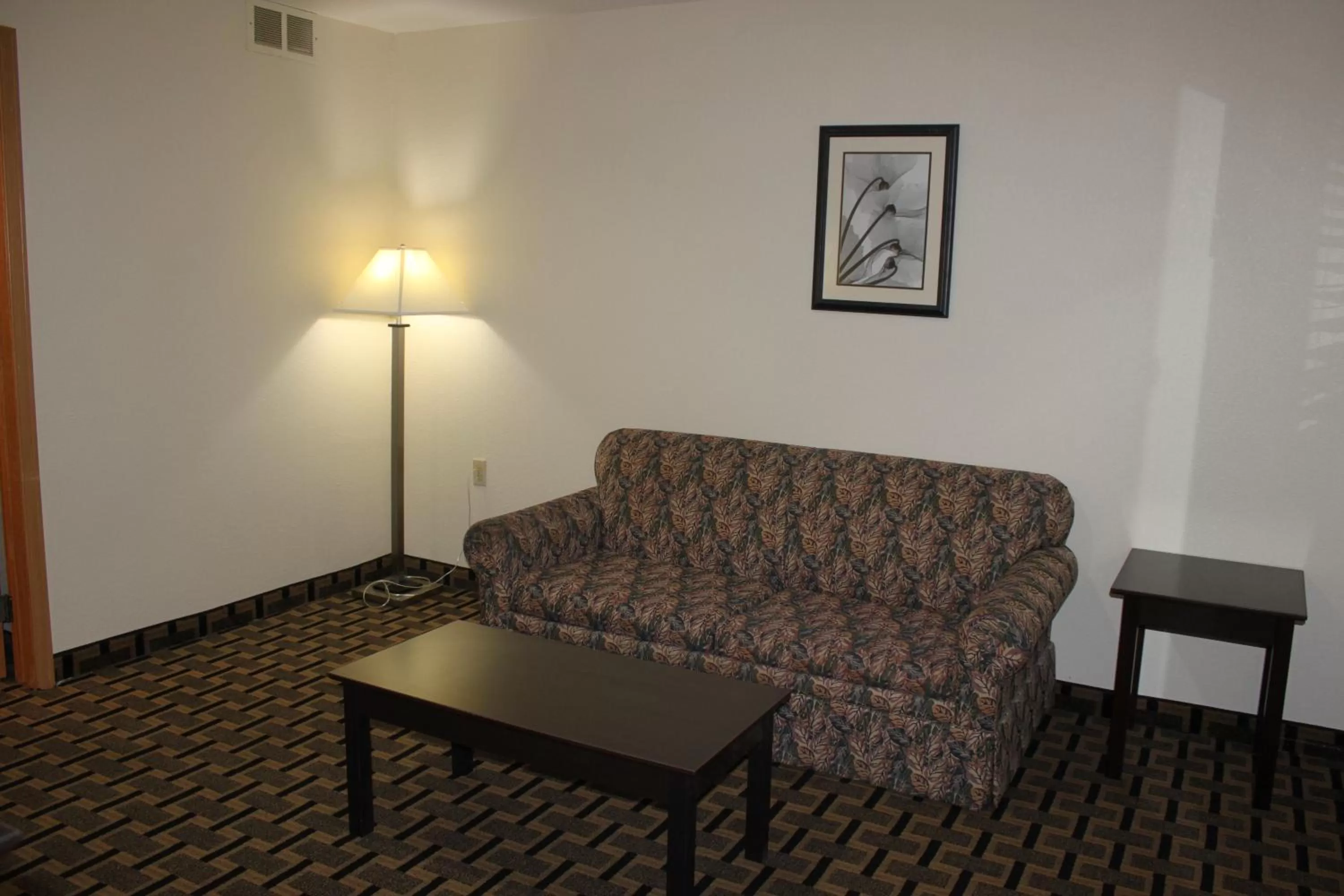Living room in AmericInn by Wyndham West Burlington