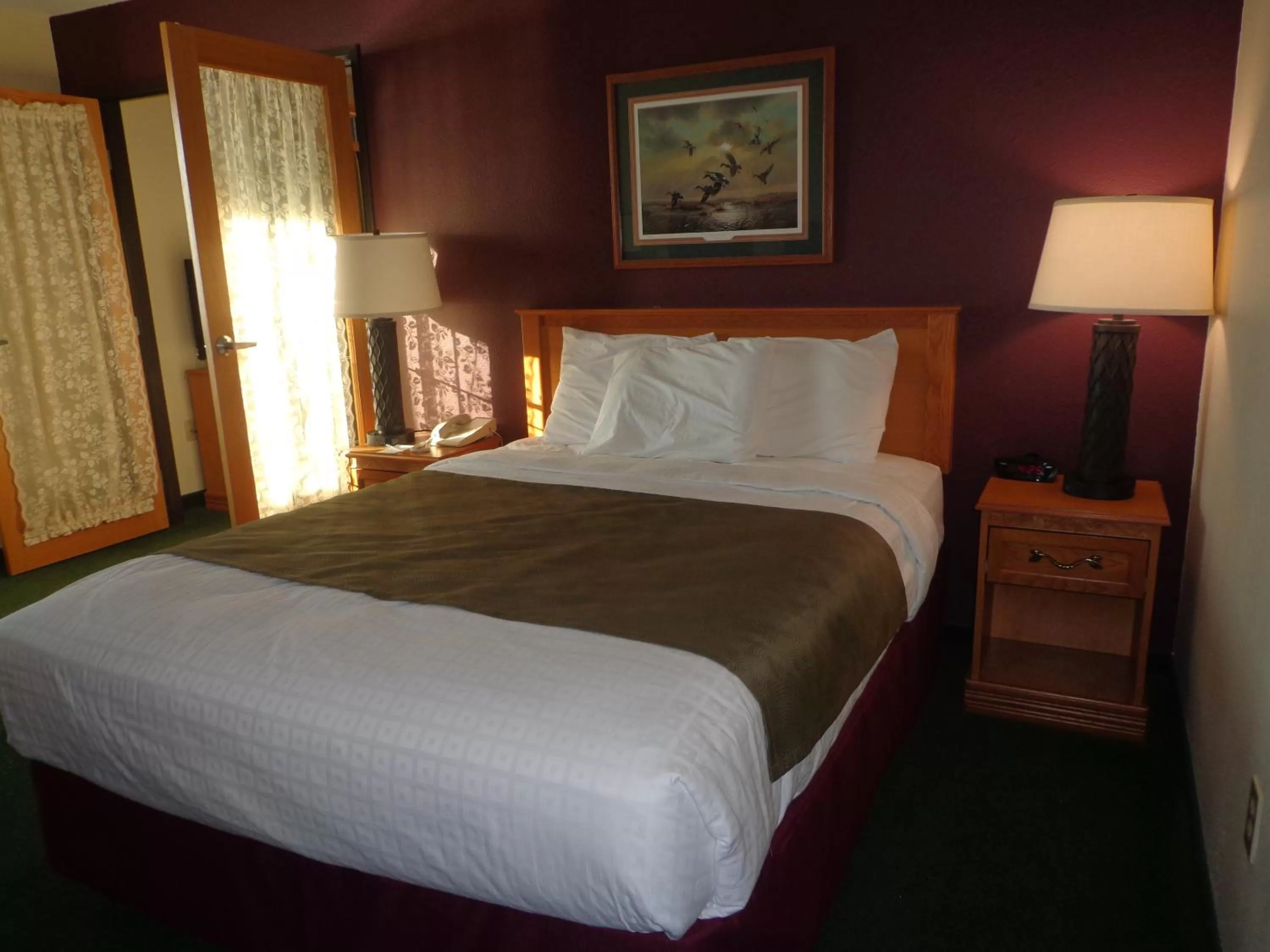 Bed in AmericInn by Wyndham Madison SD