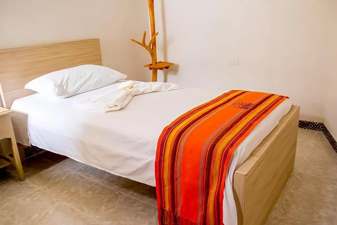 Bed in Hotel Iraka Zenu