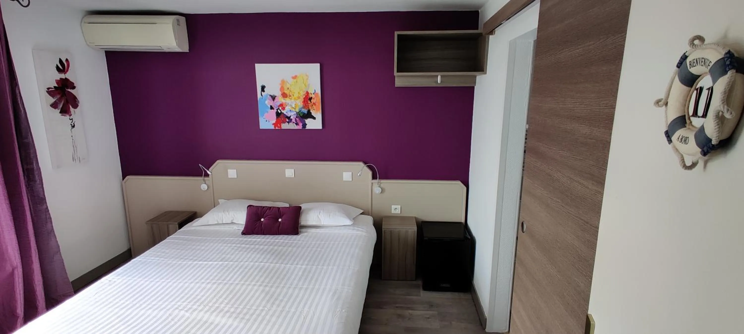 Bed in Logis Hôtel Les Bleuets