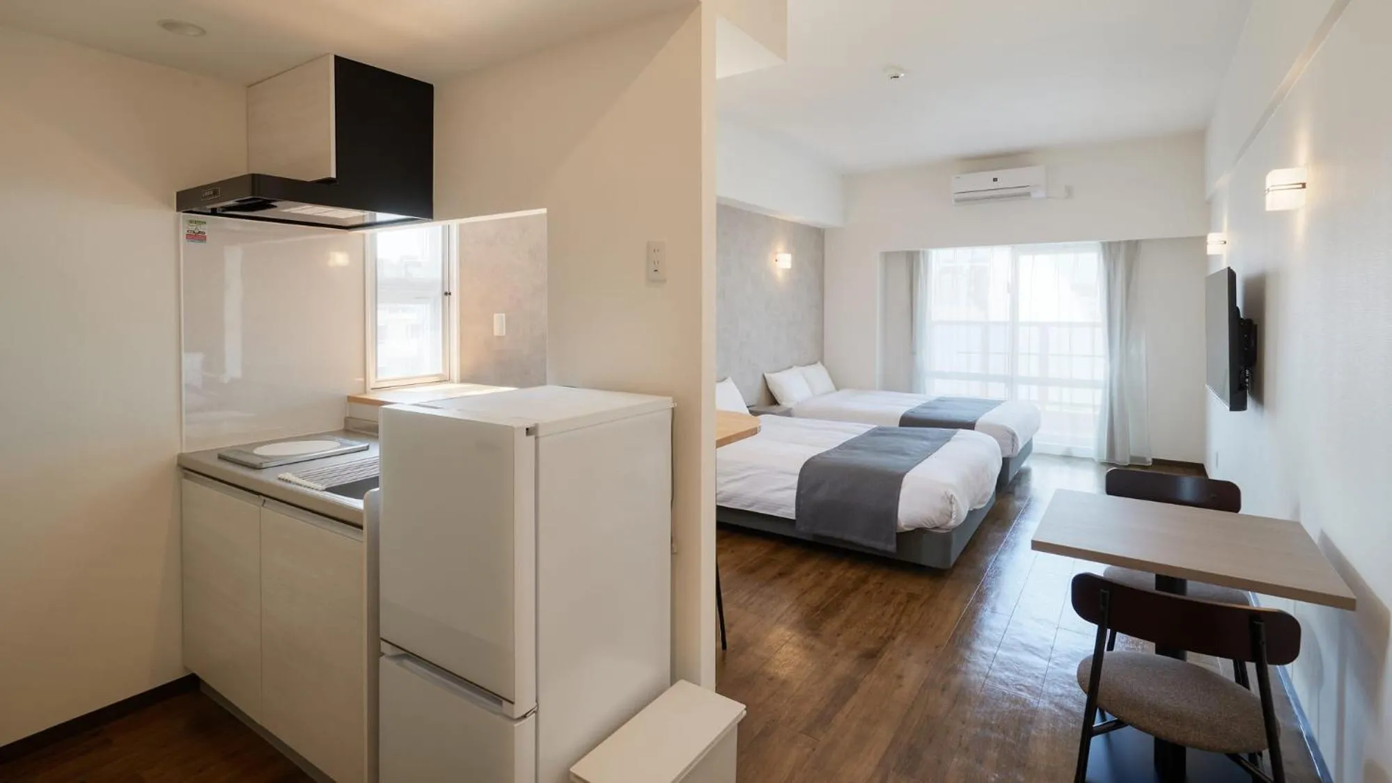 Photo of the whole room, Bed in New Normal Hotel in NAMINOUE ニューノーマルホテルイン波の上