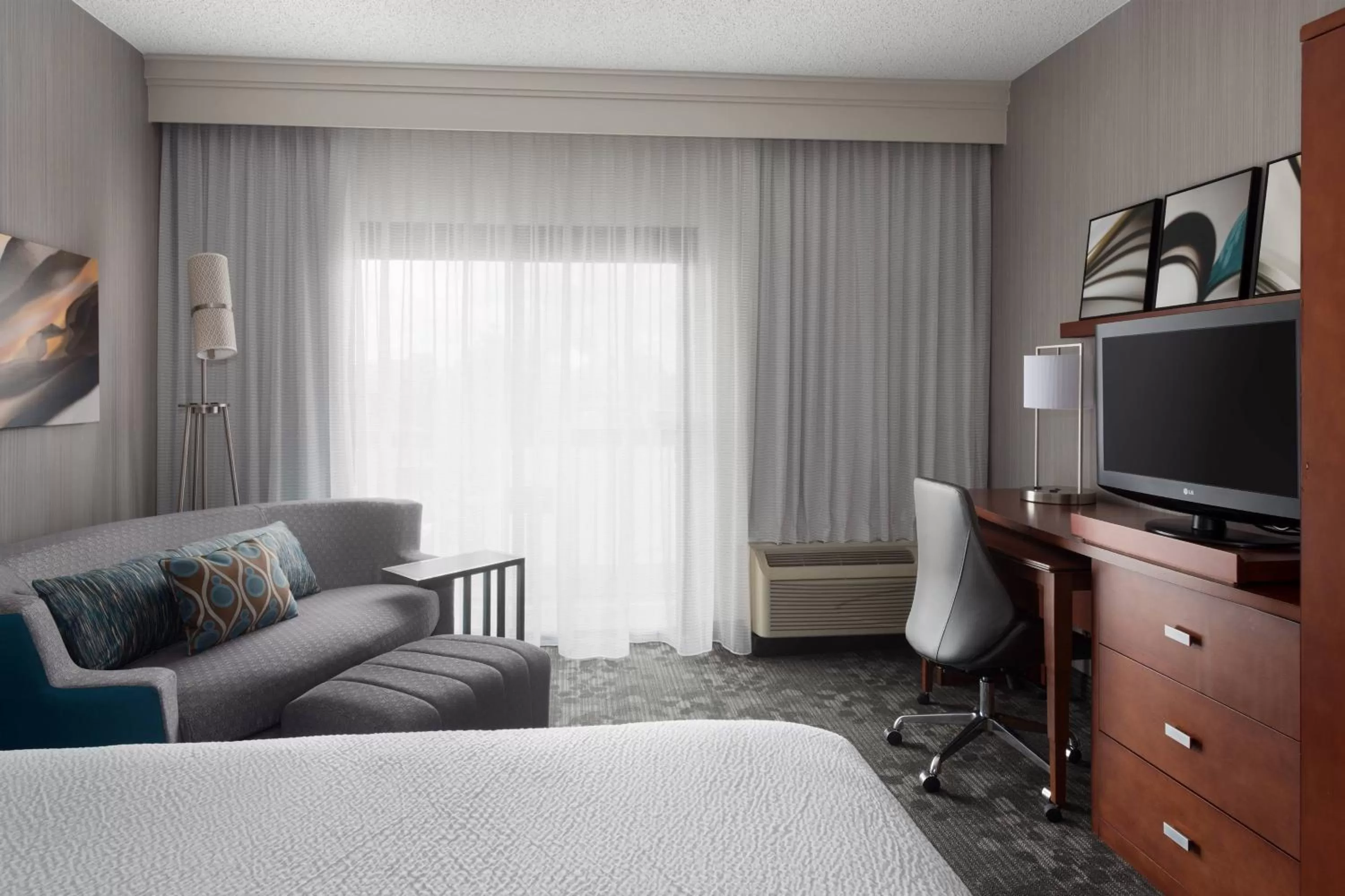 Newly Redesigned King Room with Sofa Bed and Adapted Tub - Mobility and Hearing Accessible in Courtyard Syracuse Carrier Circle