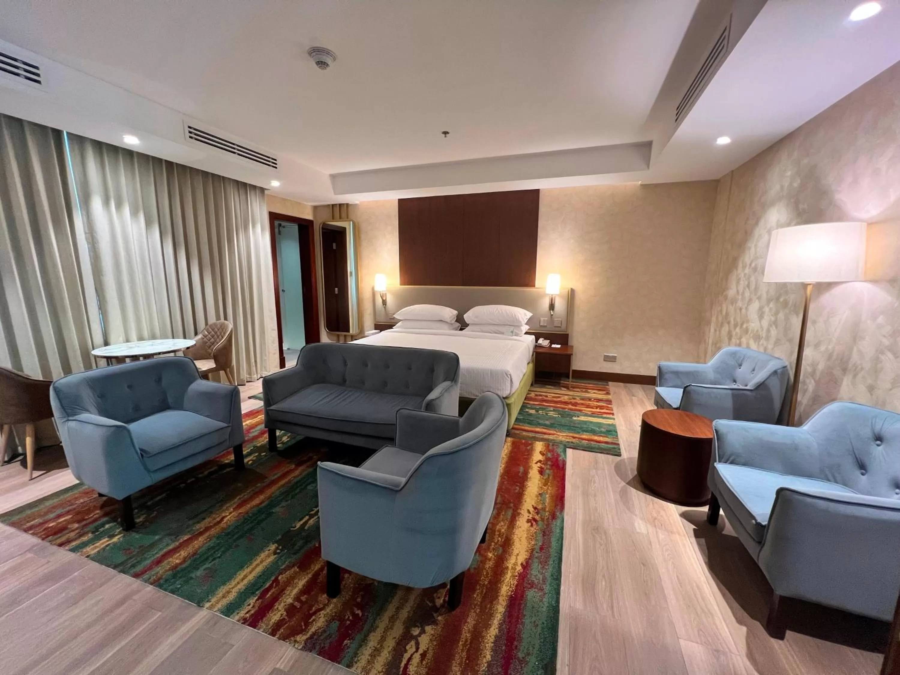 Seating area, Bed in City Seasons Suites