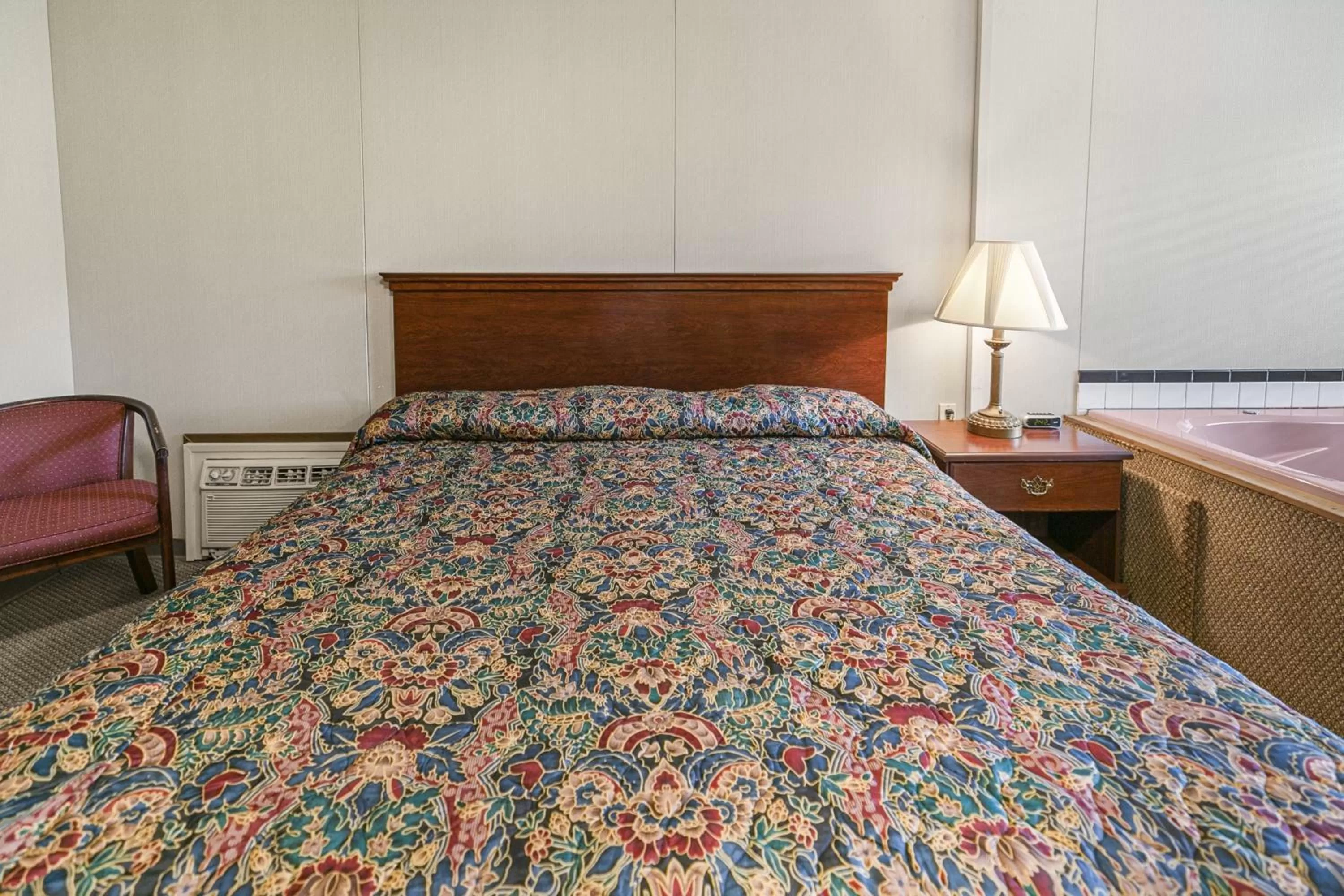 Bed in Candlewick Inn and Suites