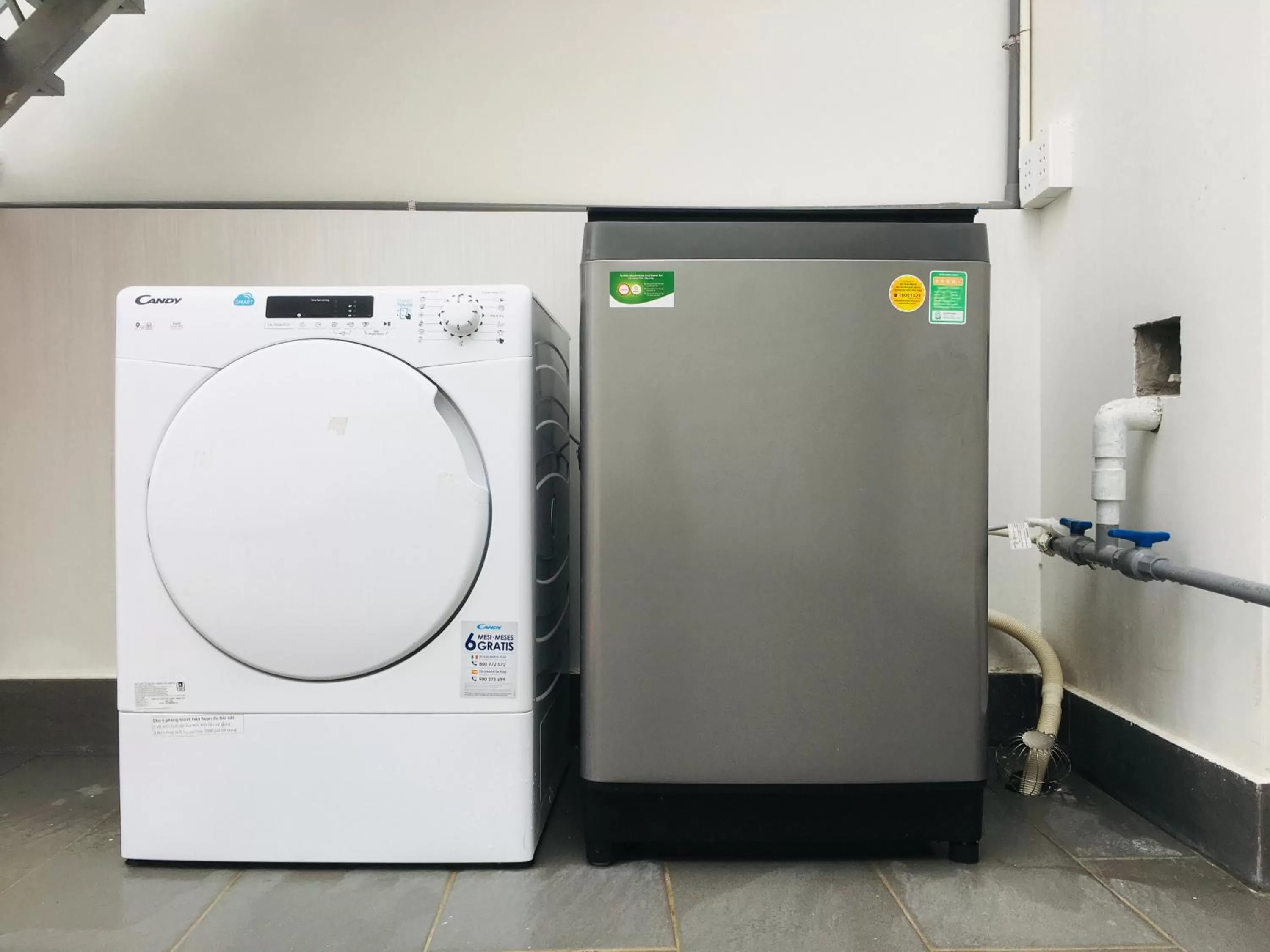 washing machine in The Green House - Serviced Apartment