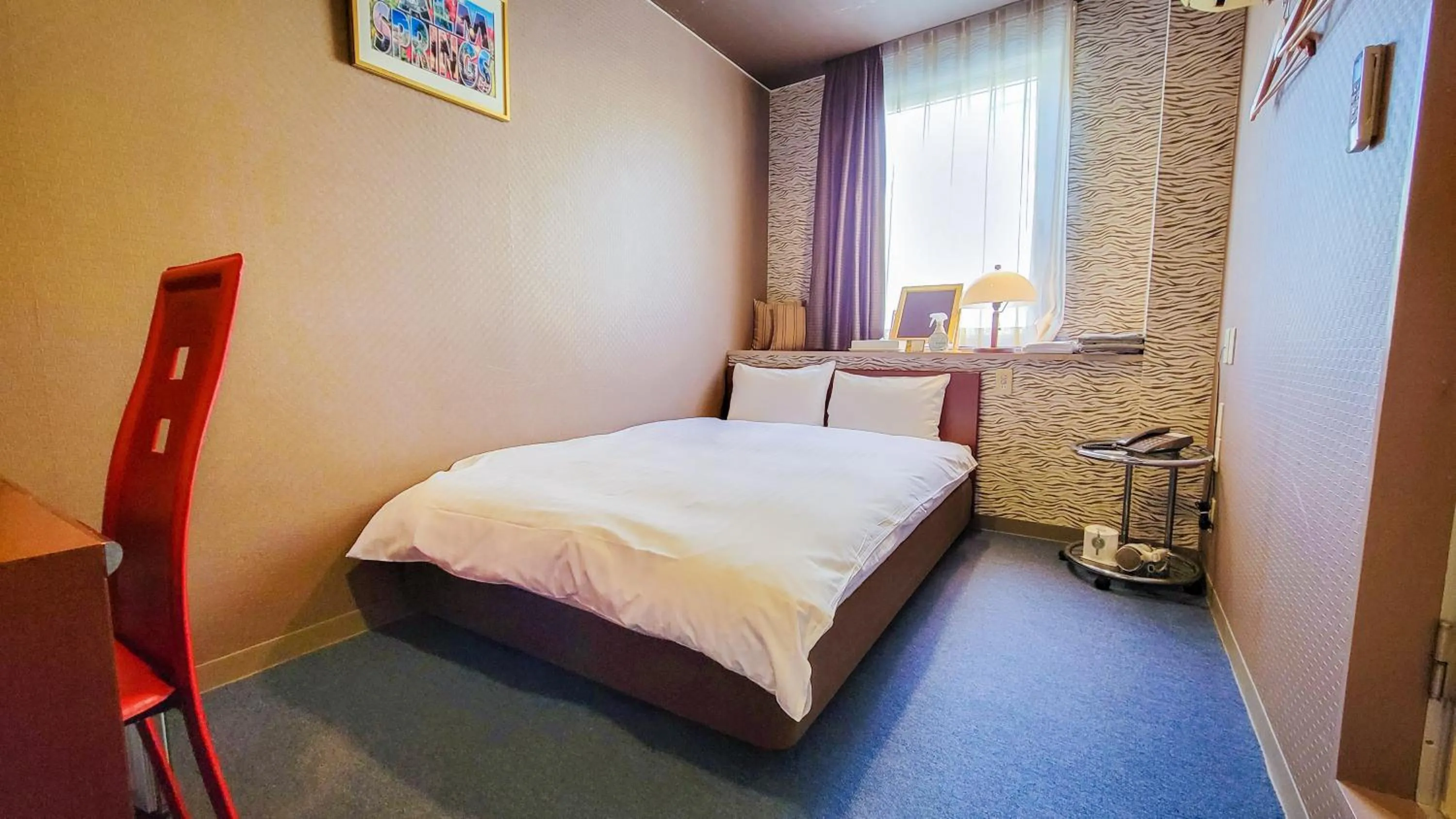 Bed in Hotel Palms Tenmonkan