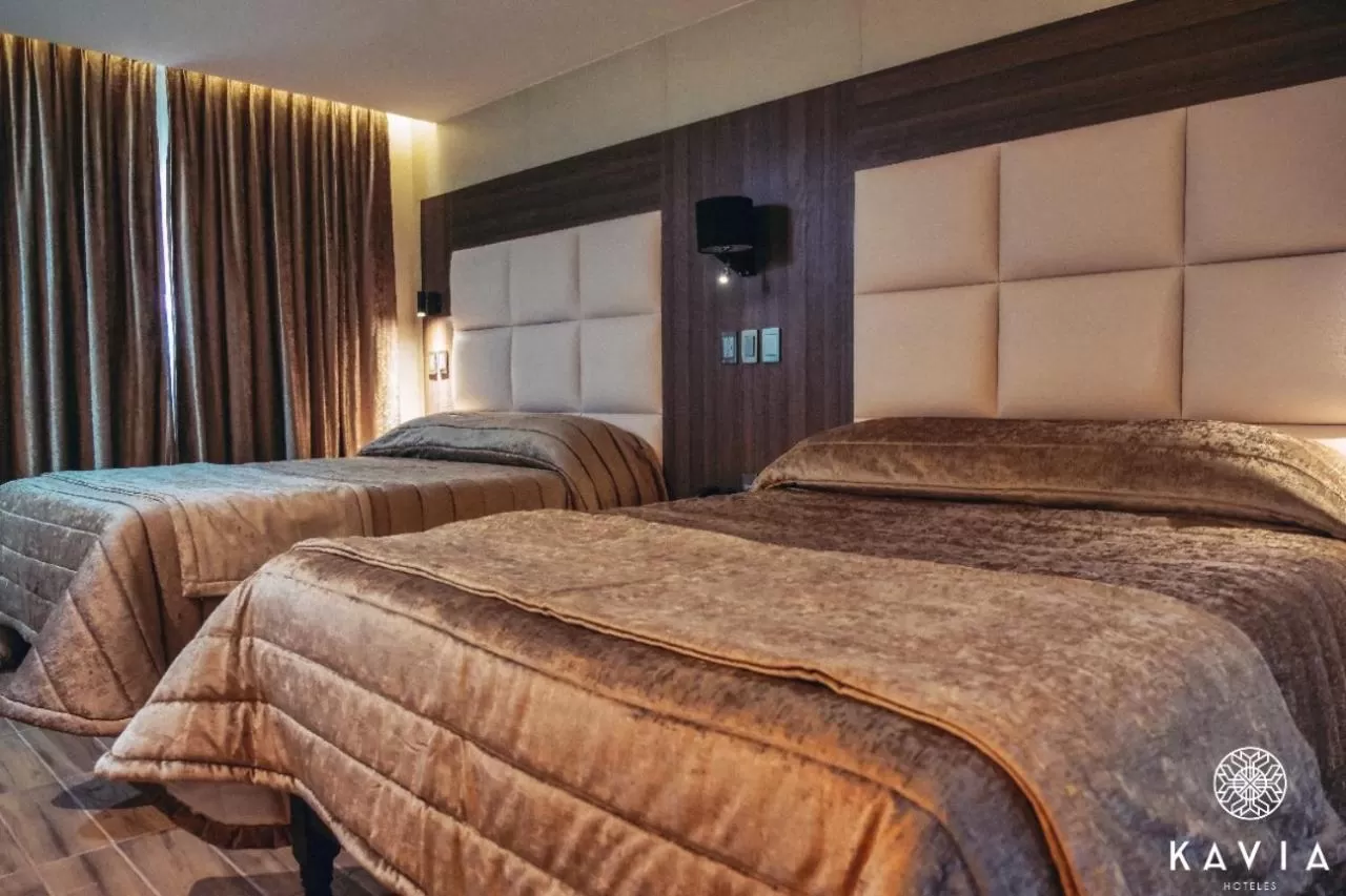 Bed in KAVIA MEOQUI HOTEL & SUITES