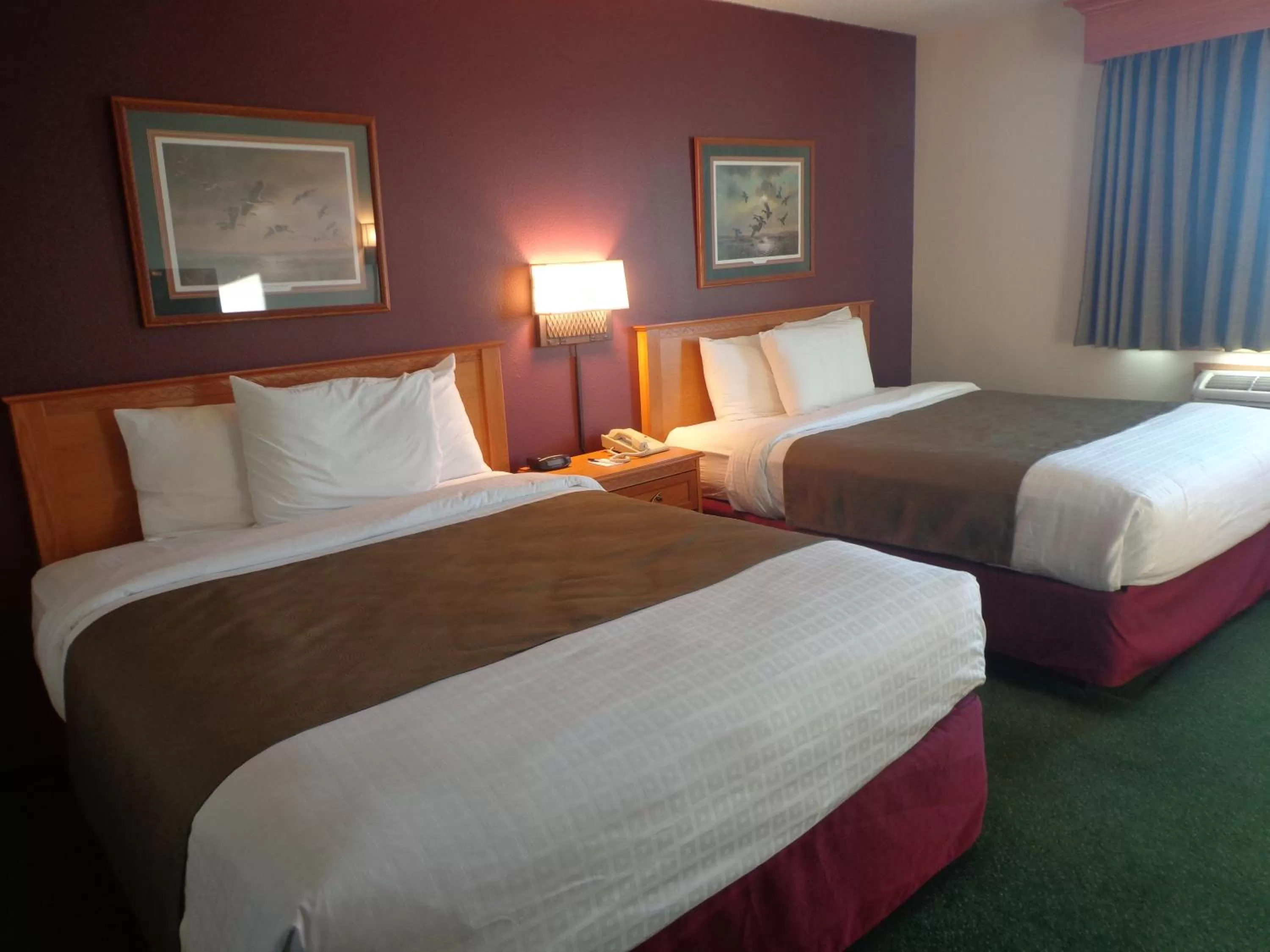 Bed in AmericInn by Wyndham Madison SD