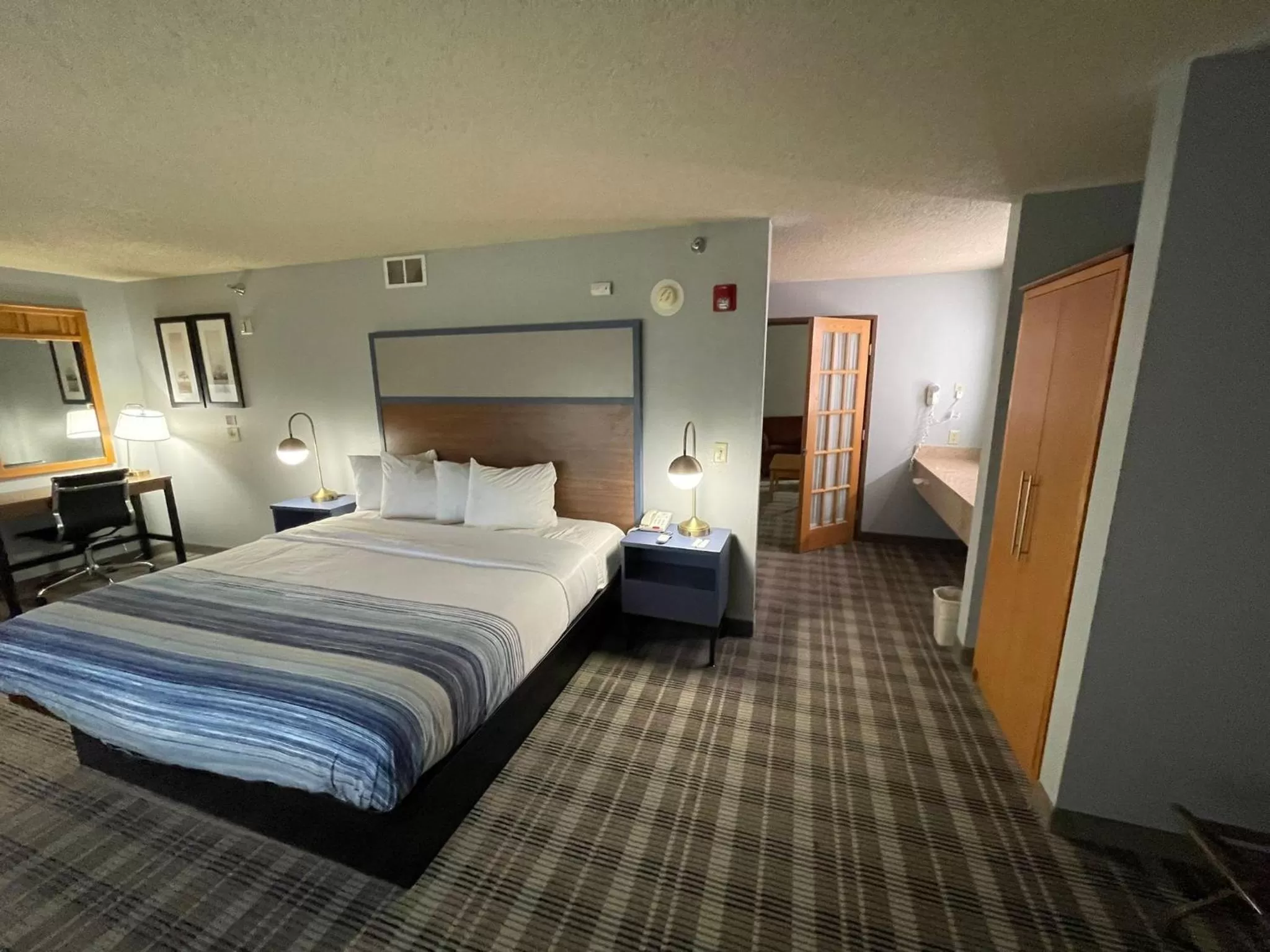 Bed in AmericInn by Wyndham Sayre