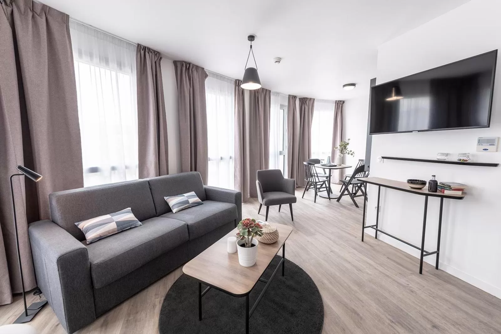 Communal lounge/ TV room in Appart'City Collection Saint Germain en Laye