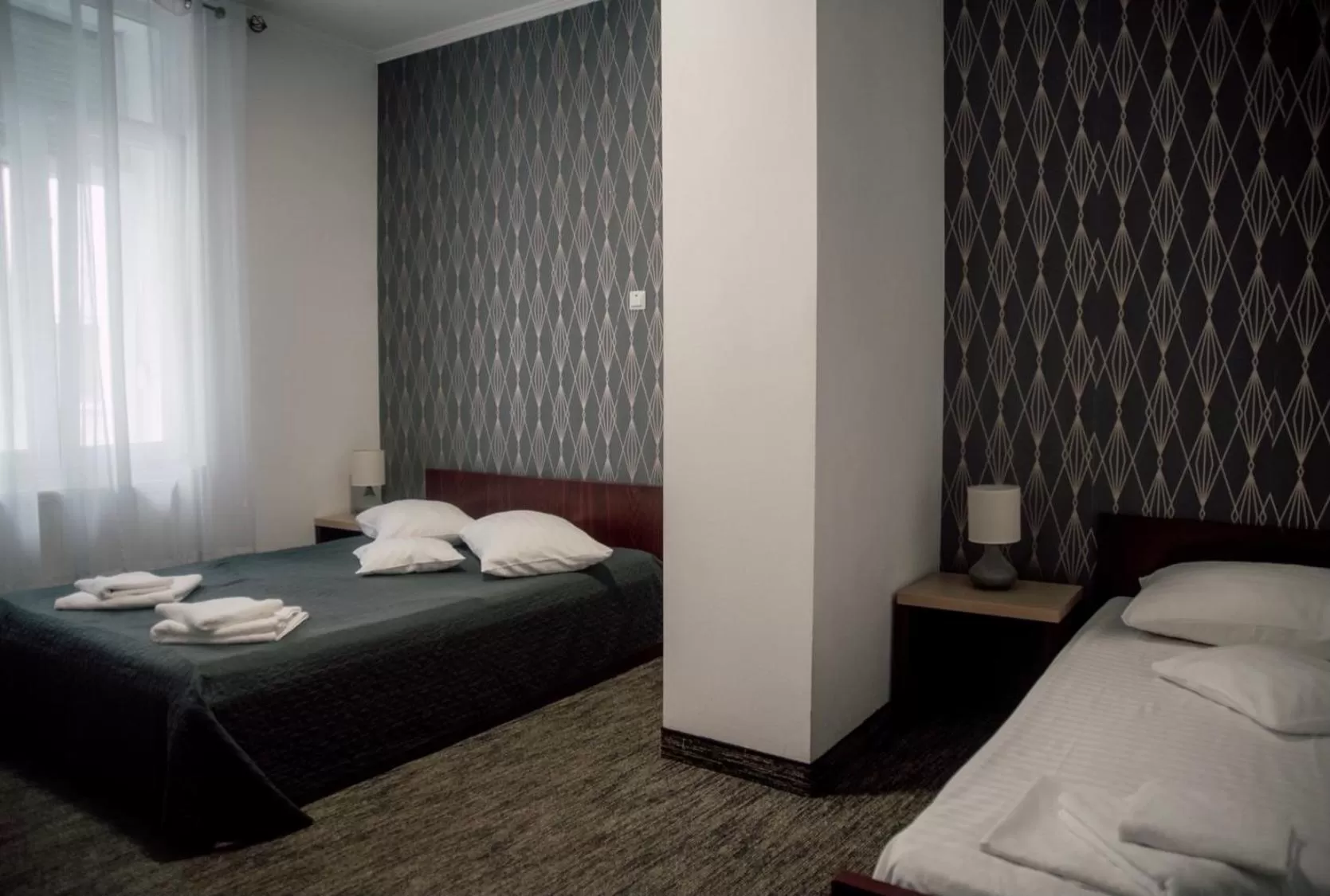 Bed in Carnival City Hotel Oradea