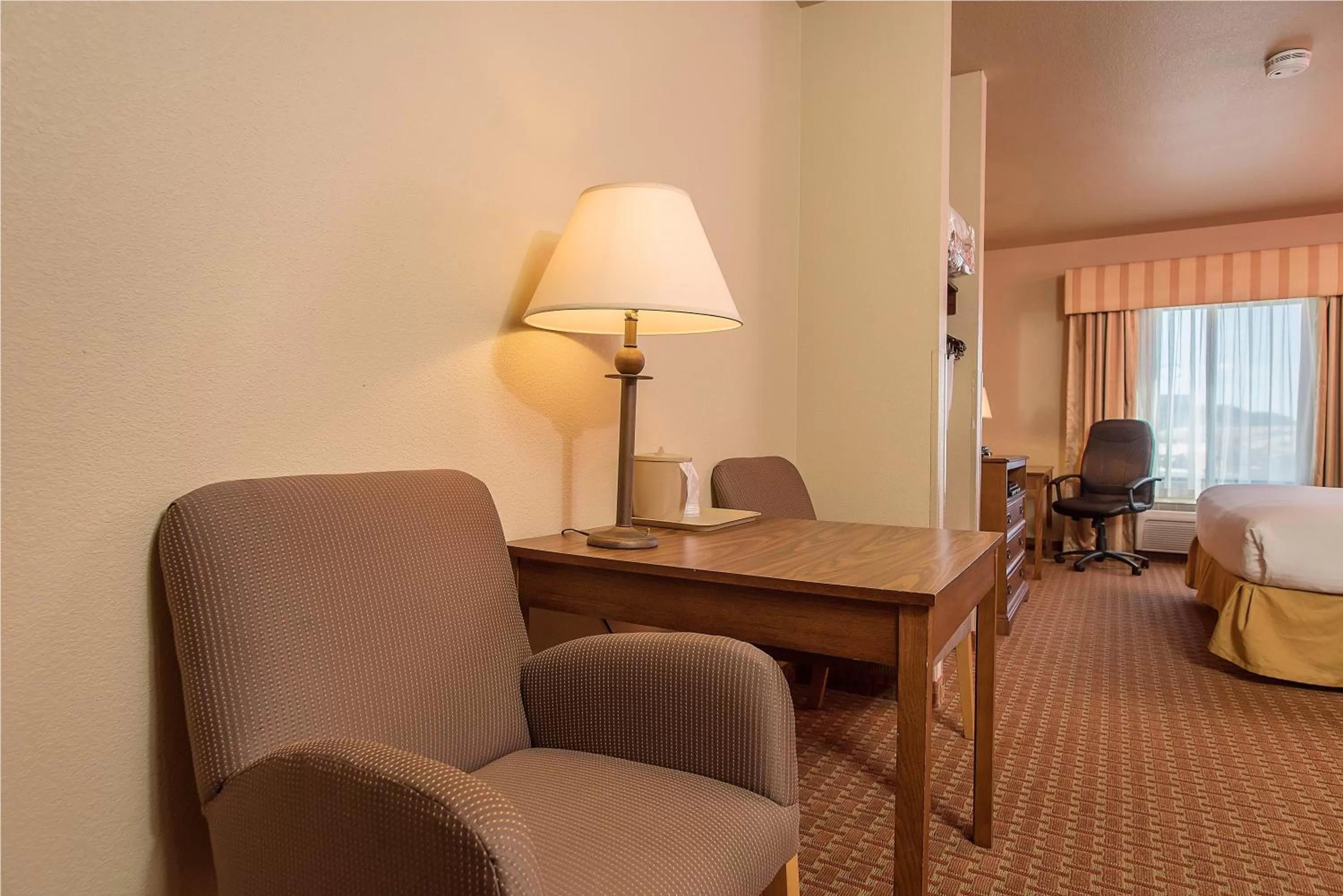 Seating area, Bed in Baymont Inn & Suites by Wyndham Sturgis