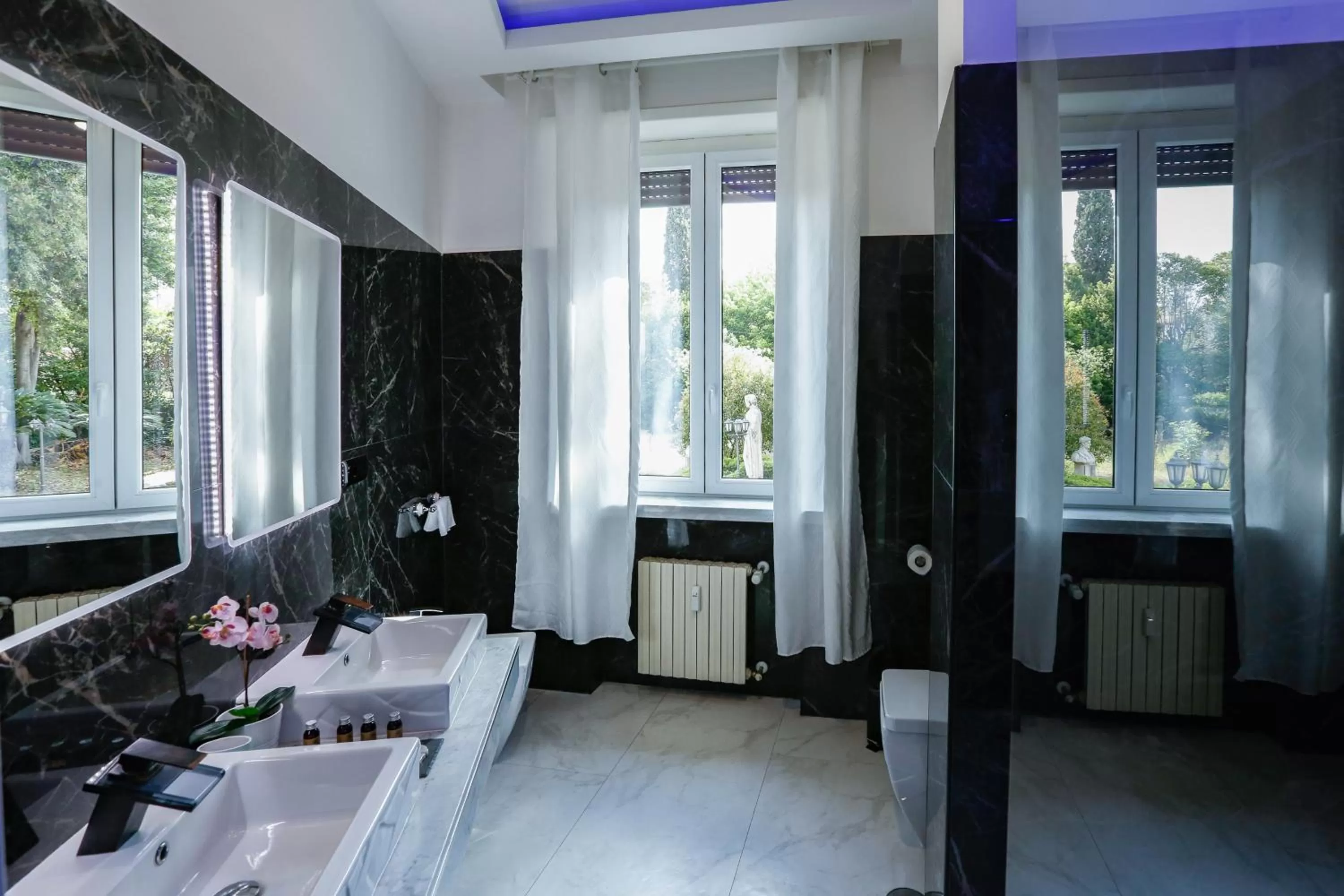 Toilet, Bed in Escape Luxury Suite - CA Domus Collection