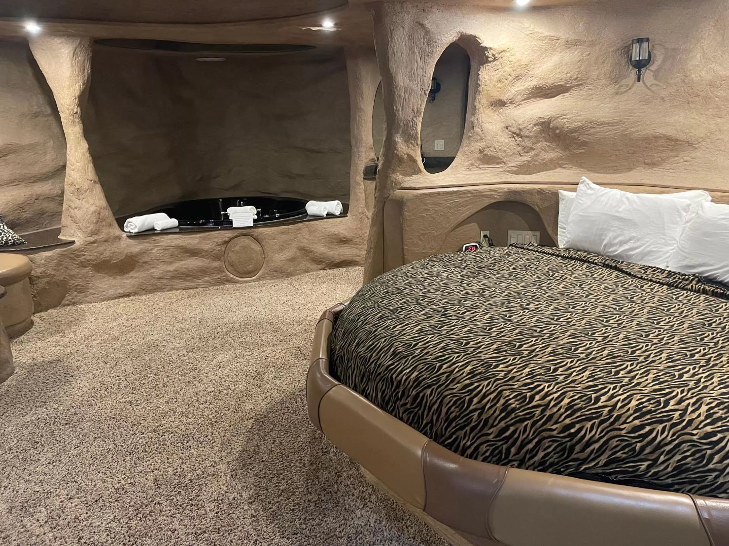 Bed in Designer Inn and Suites