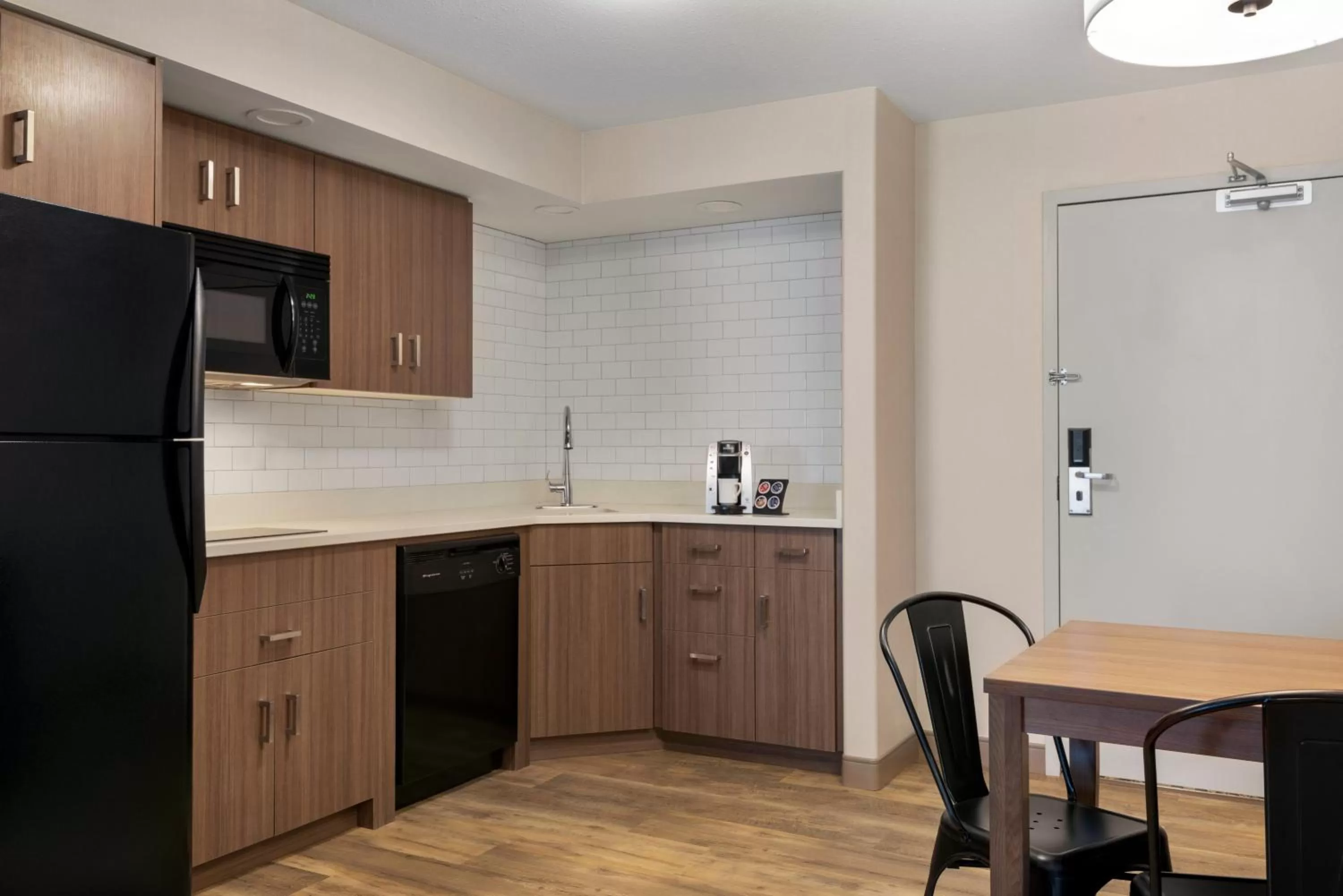 Kitchen or kitchenette in Ramada by Wyndham Airdrie Hotel & Suites
