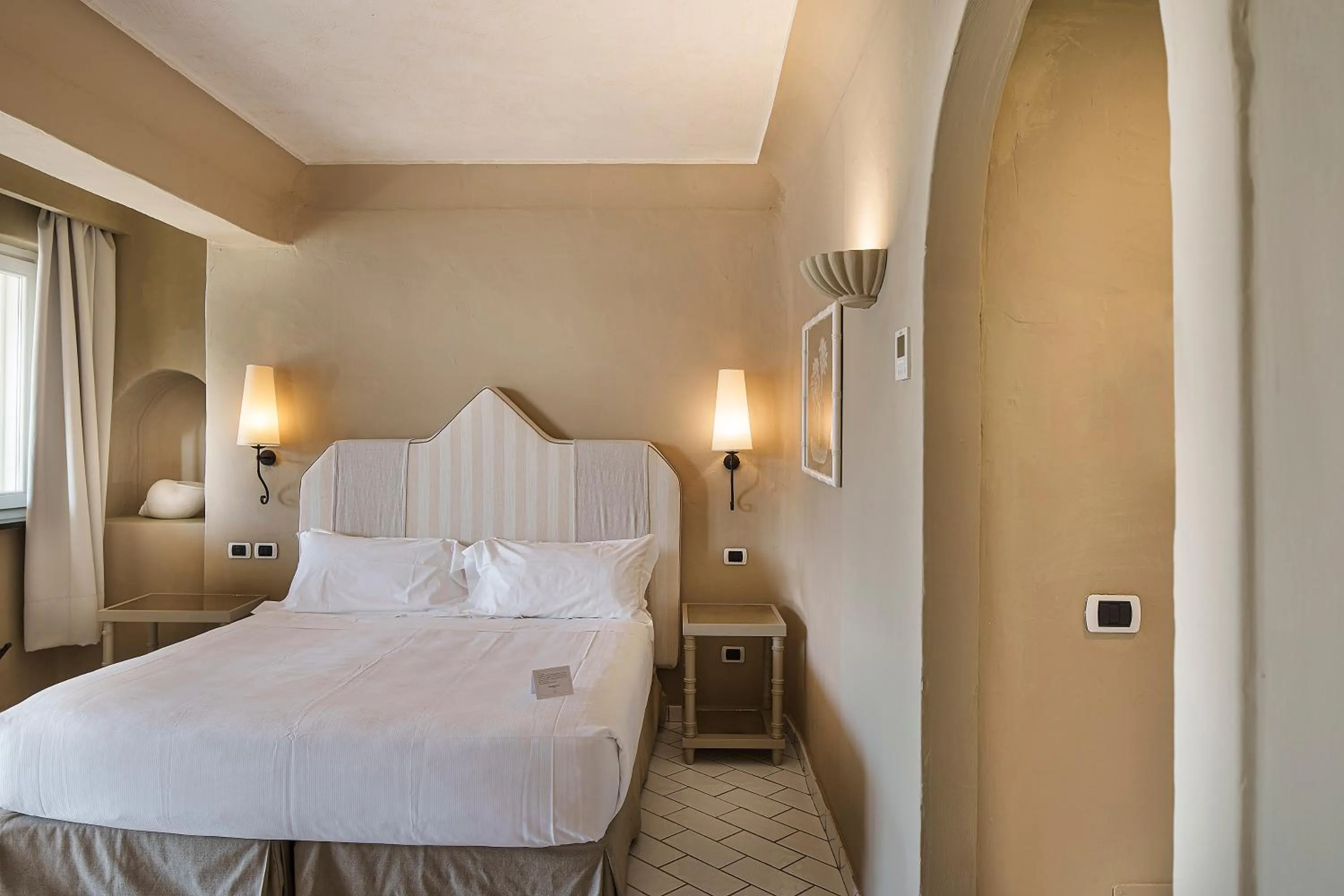 Bed in Therasia Resort Sea and SPA - The Leading Hotels of the World