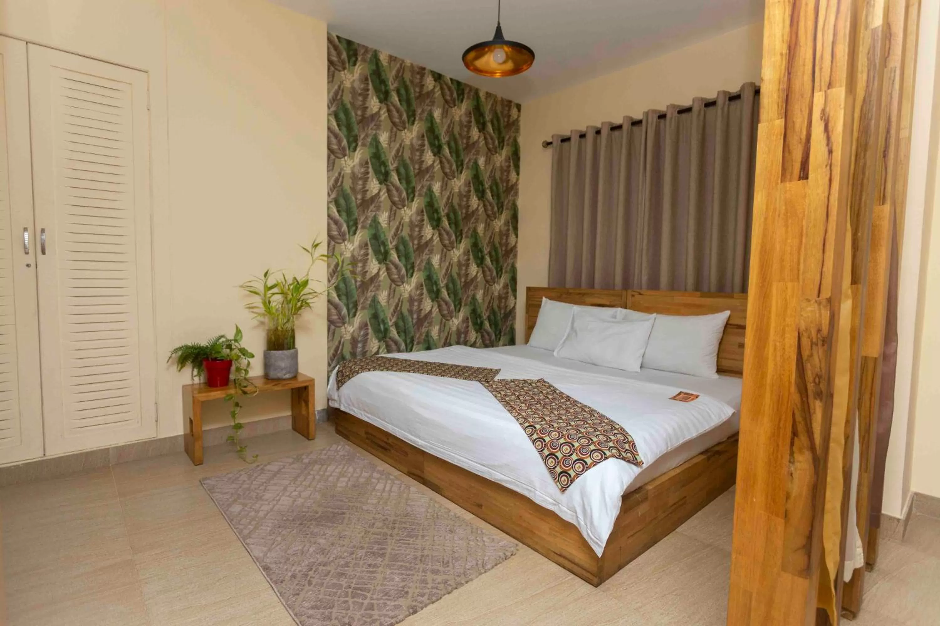 Bed in Roots Hotel Apartment