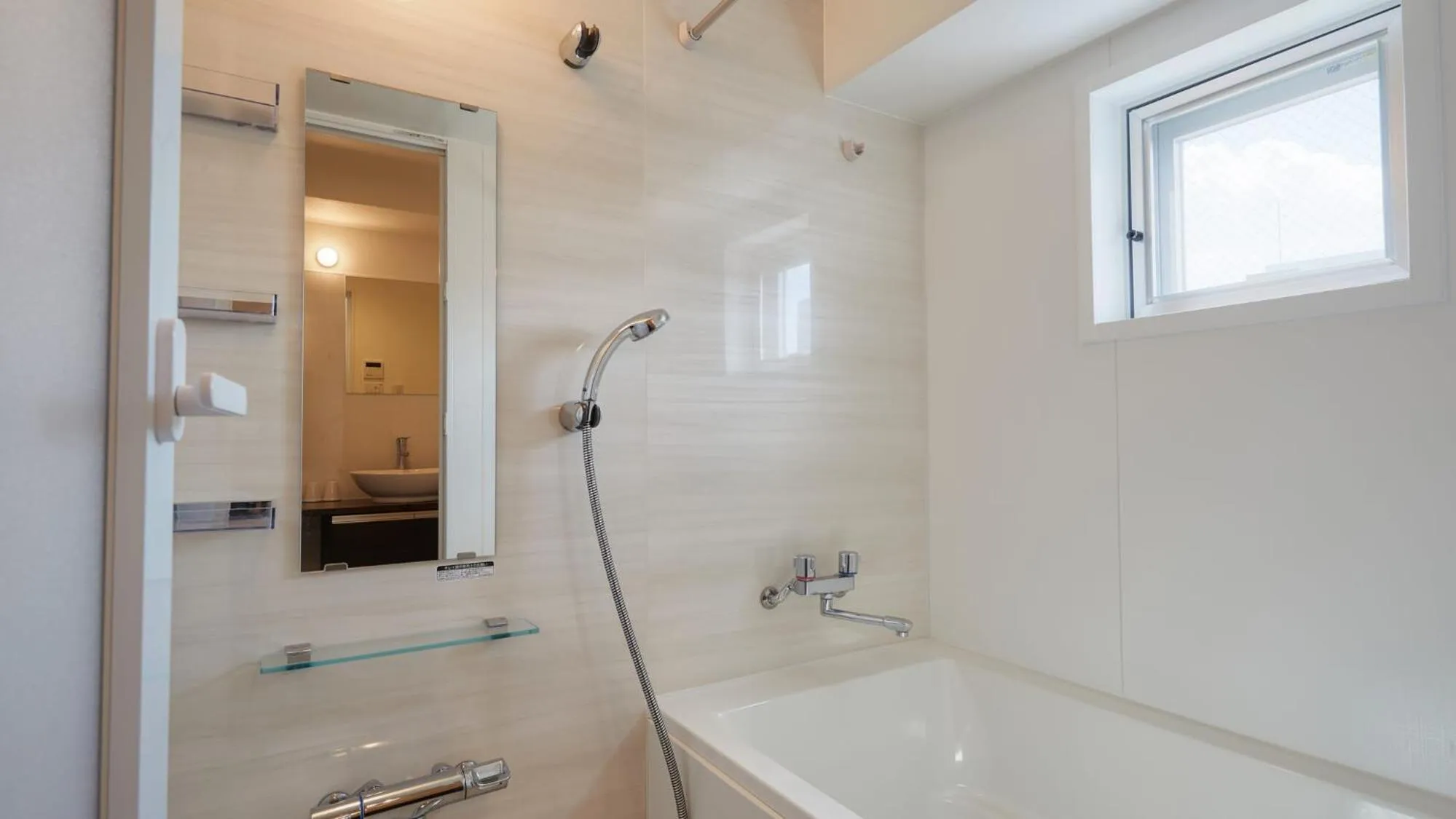 Bathroom in New Normal Hotel in NAMINOUE ニューノーマルホテルイン波の上