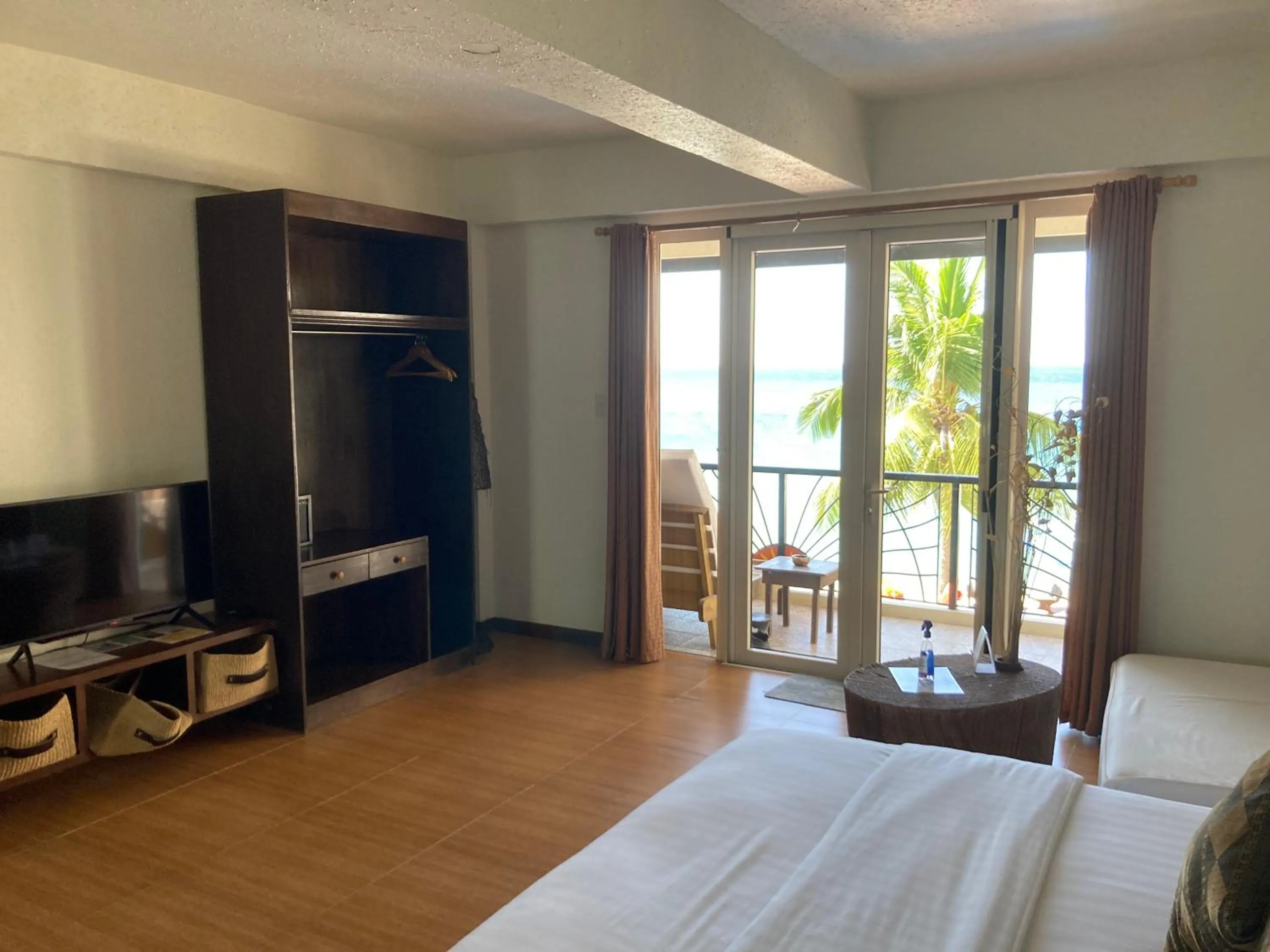 Photo of the whole room, TV/Entertainment Center in Sunset At Aninuan Beach Resort