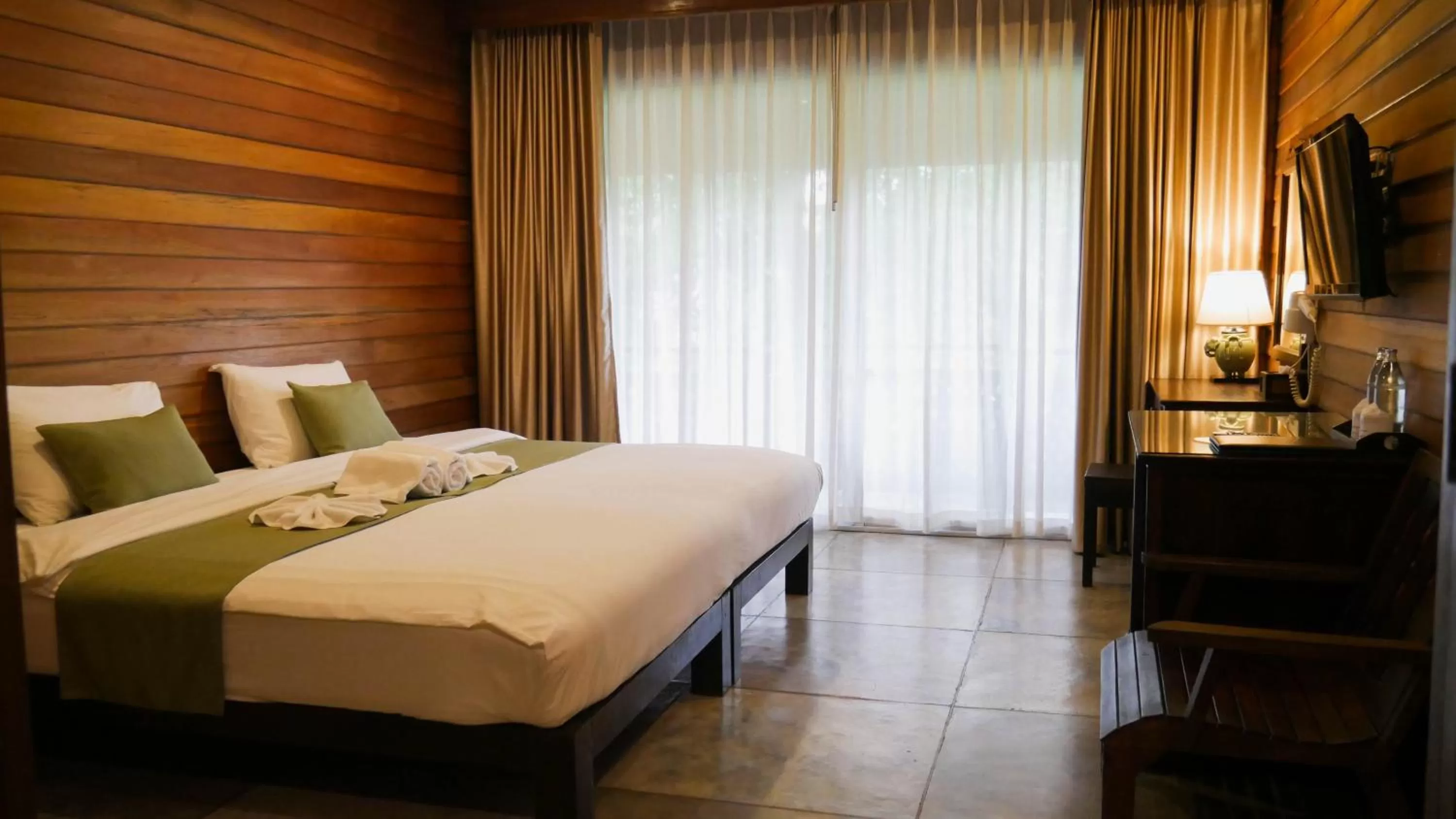 Bed in Royal River Kwai Resort and Spa