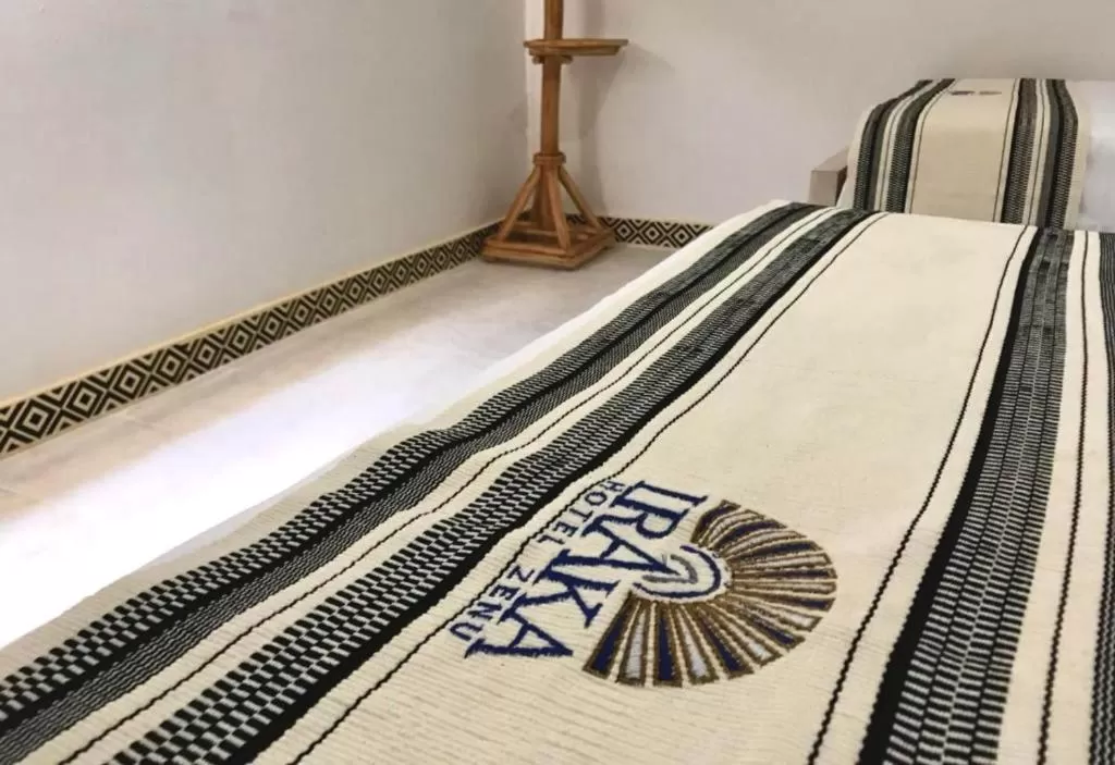 Bed in Hotel Iraka Zenu