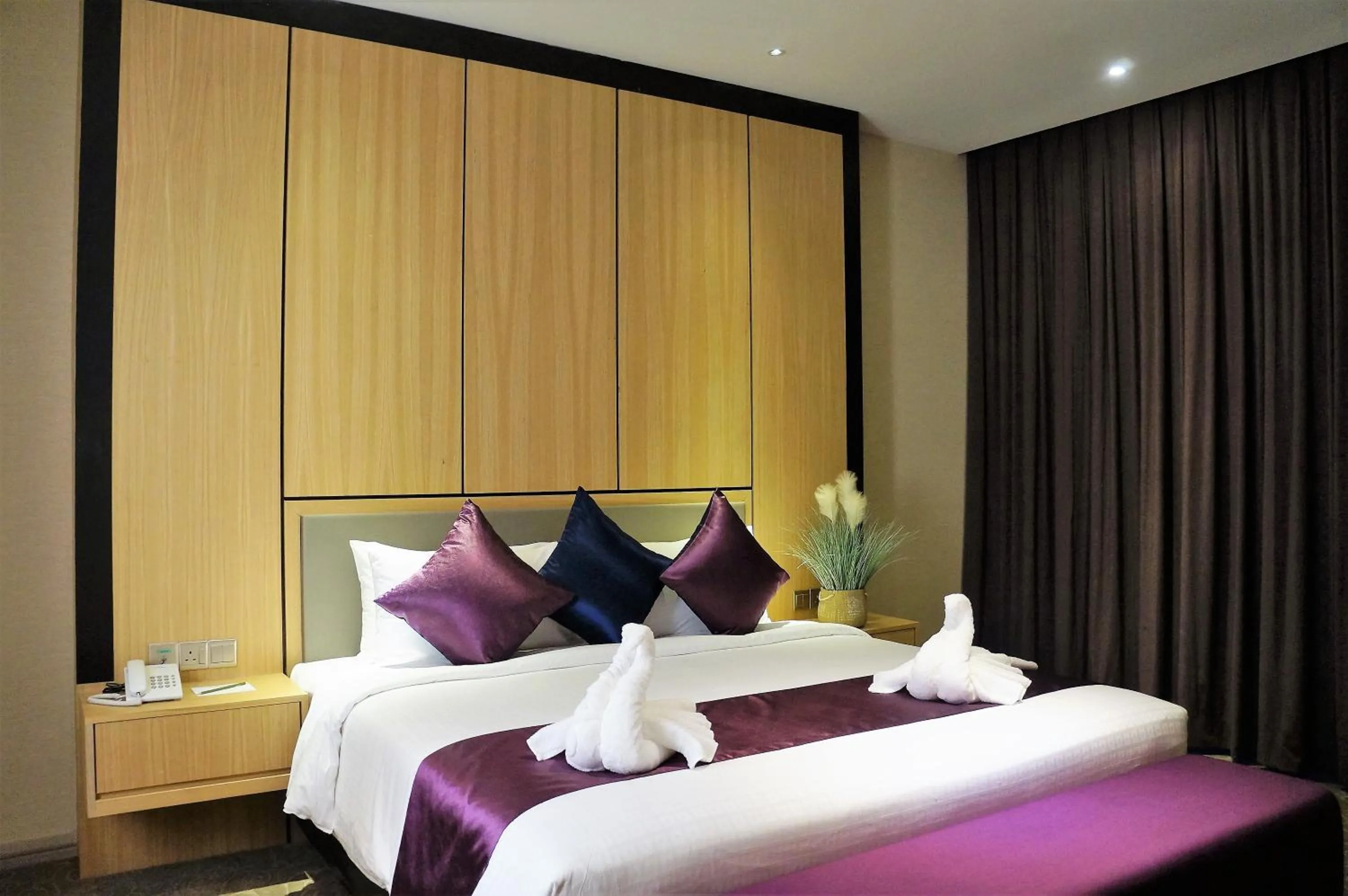 Bed in Greens Hotel & Suites