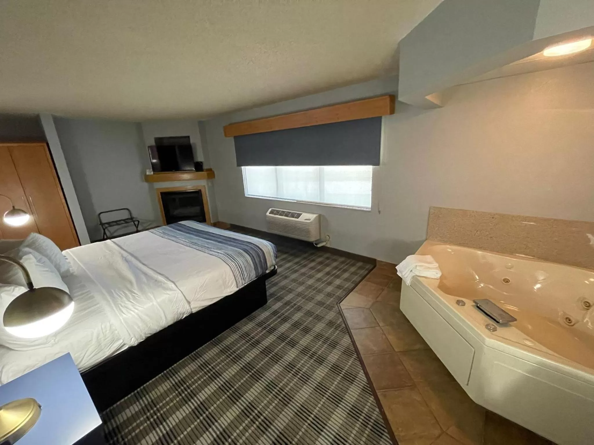 Bed in AmericInn by Wyndham Sayre