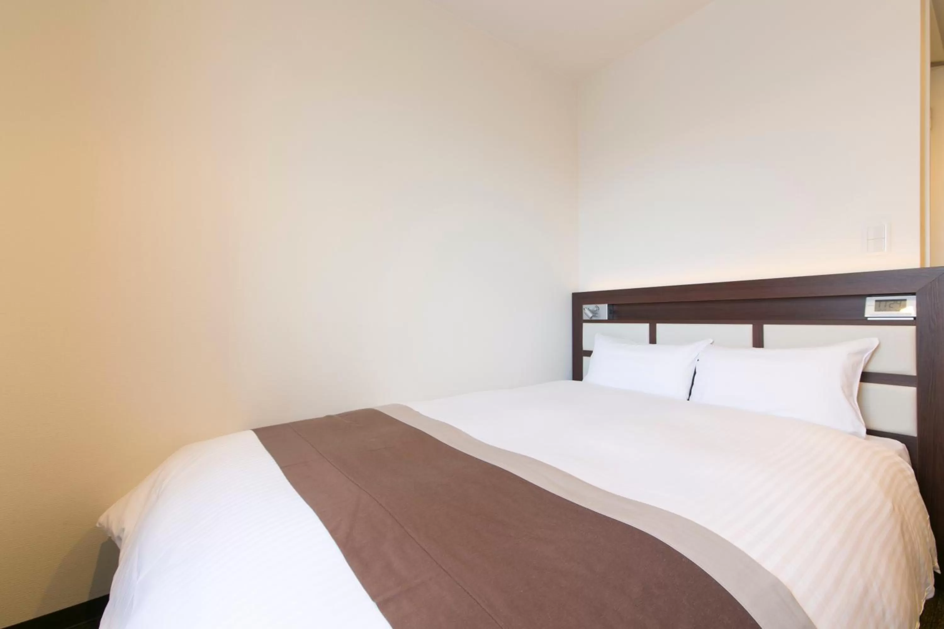 Bed in Urban Hotel Minami Kusatsu