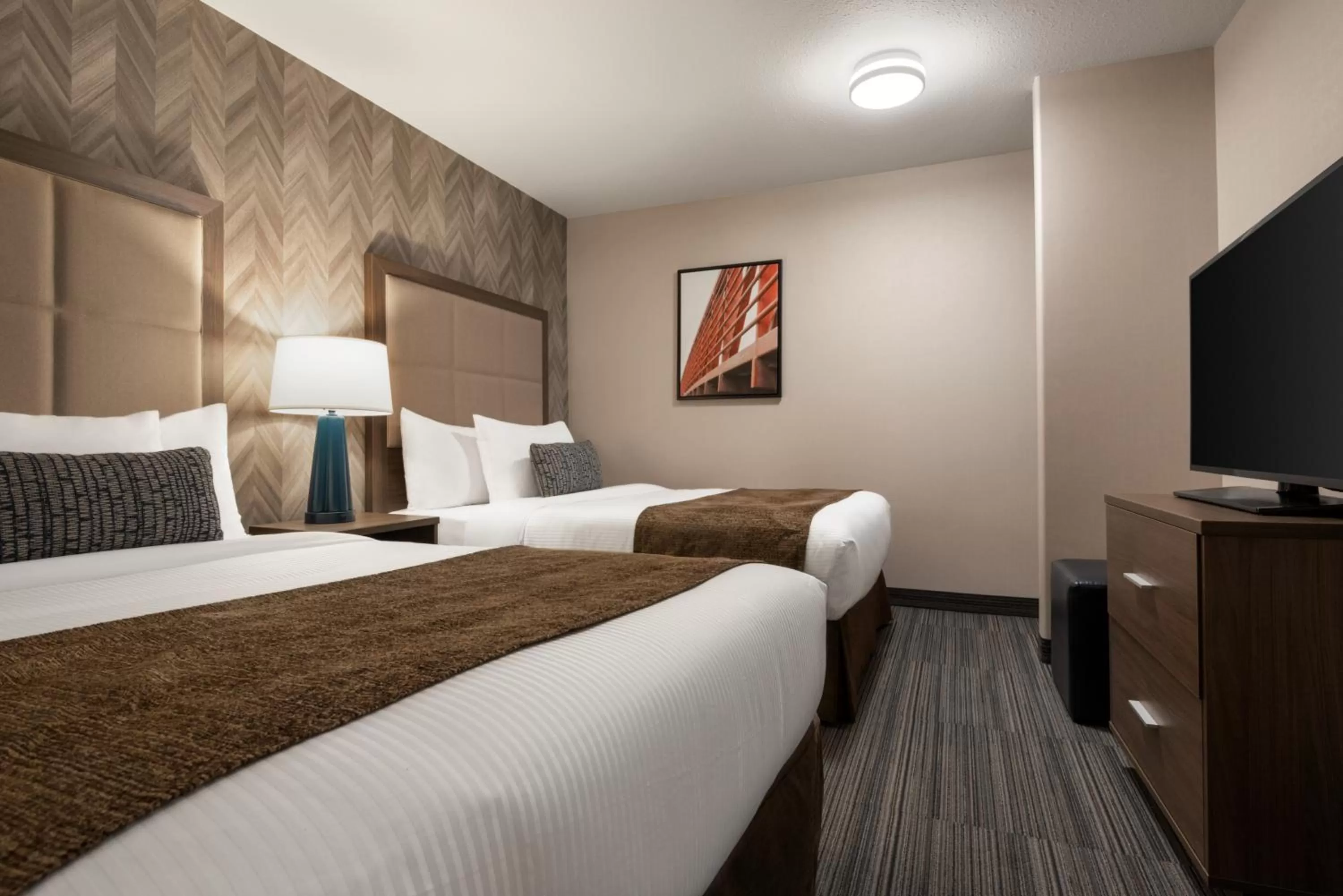 Bedroom, Bed in Ramada by Wyndham Airdrie Hotel & Suites