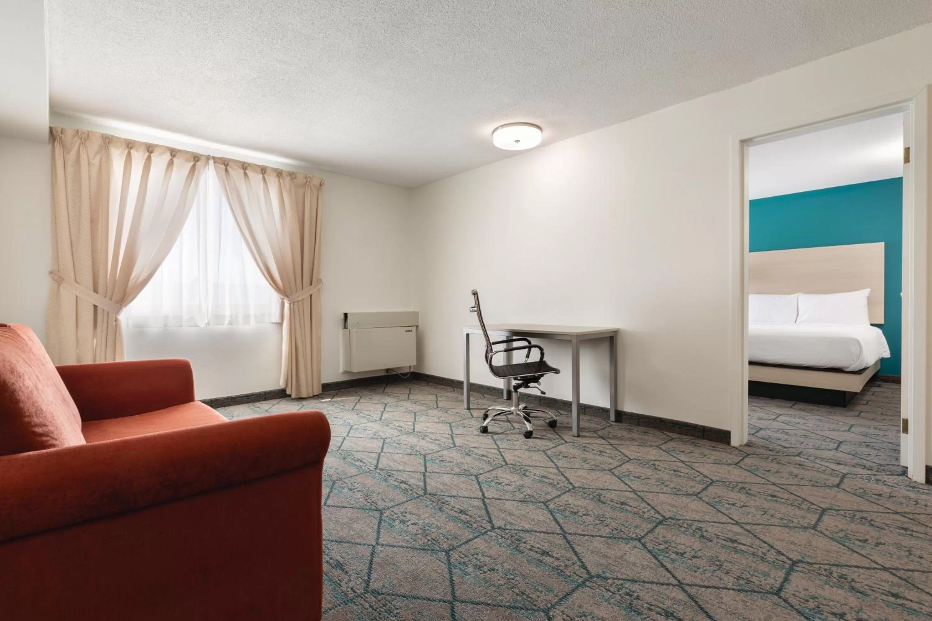 Living room, Bed in Ramada by Wyndham Miramichi New Brunswick
