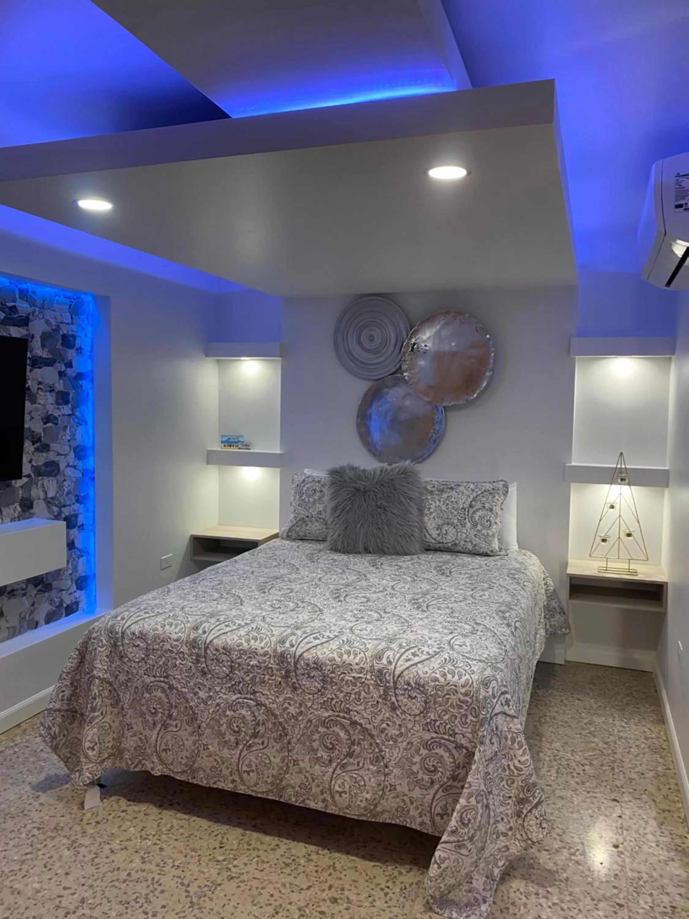 Bed in Itza-Bella Suites