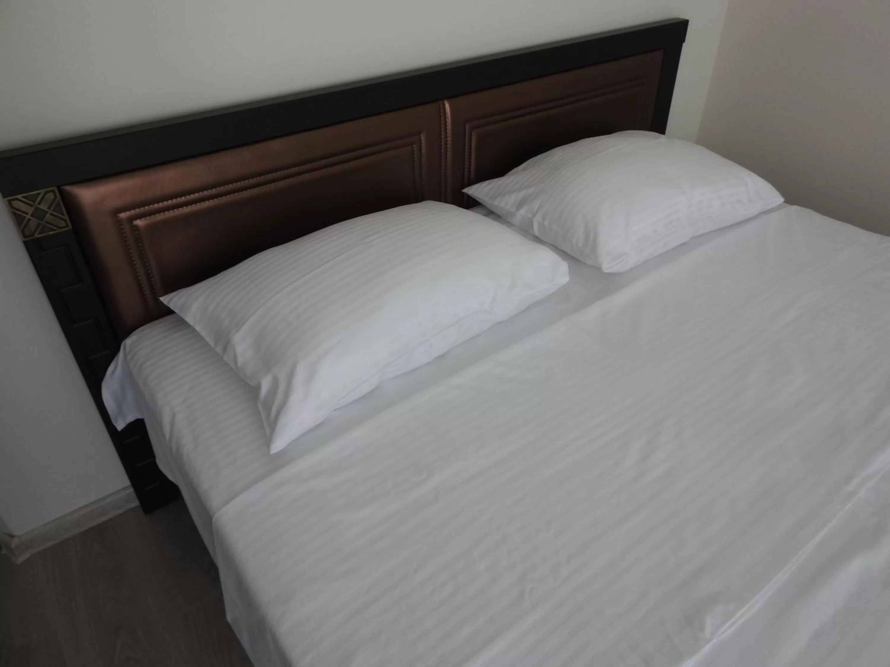 Bed in Iko's Family Apartments