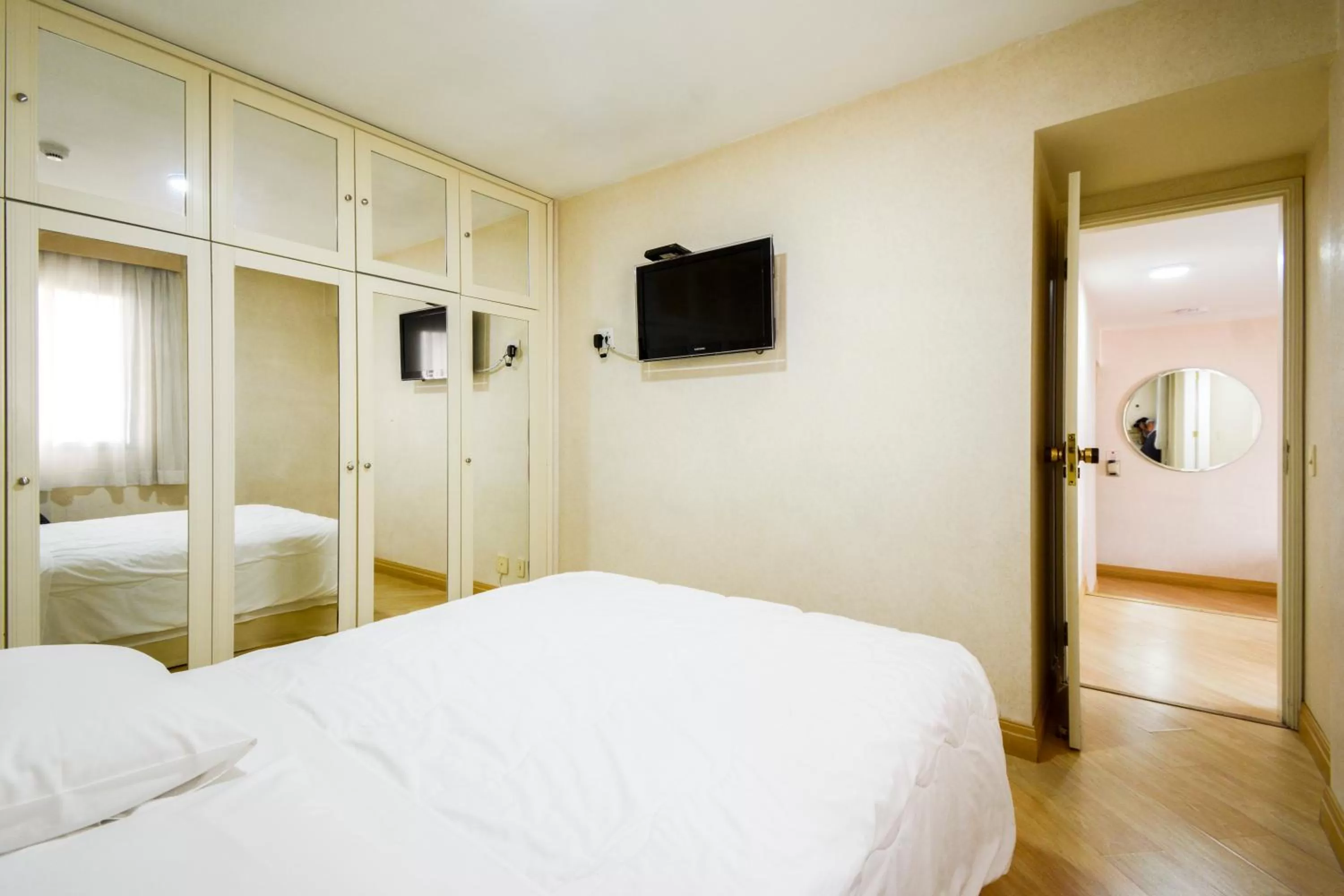 Bed in Wall Street Apartments by BnbHost