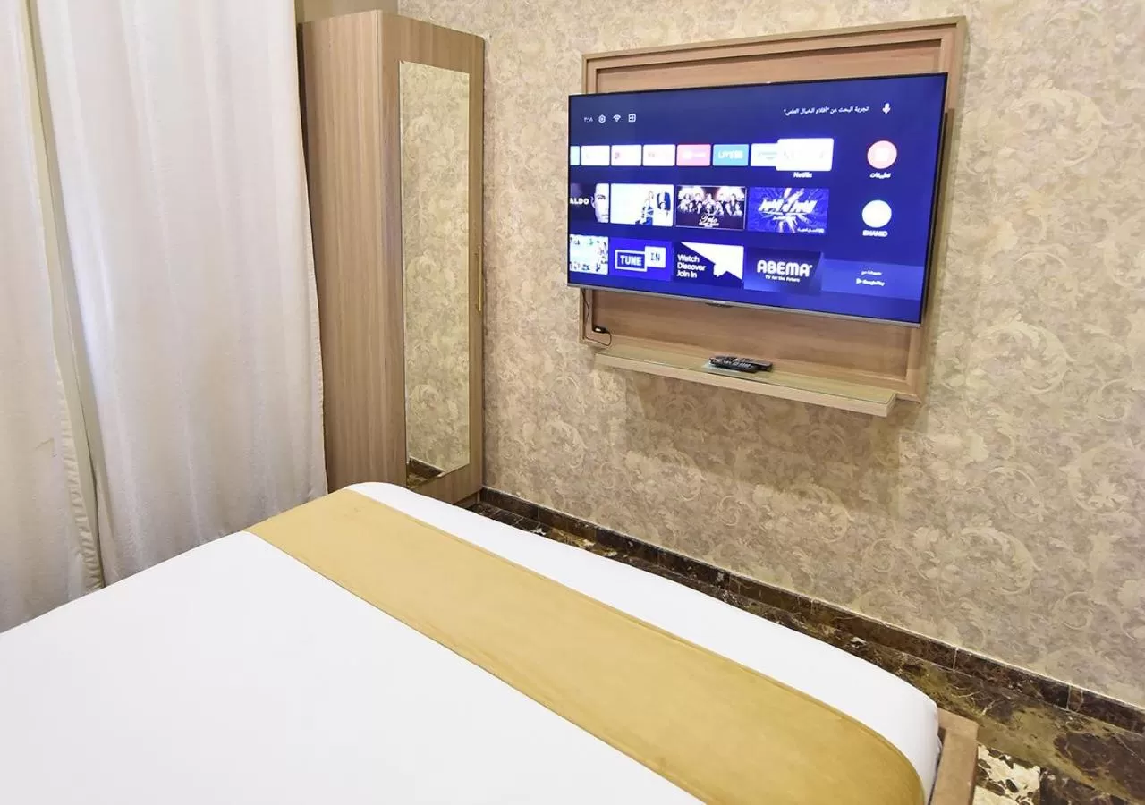Bed, TV/Entertainment Center in Rihanna Hotel Apartment