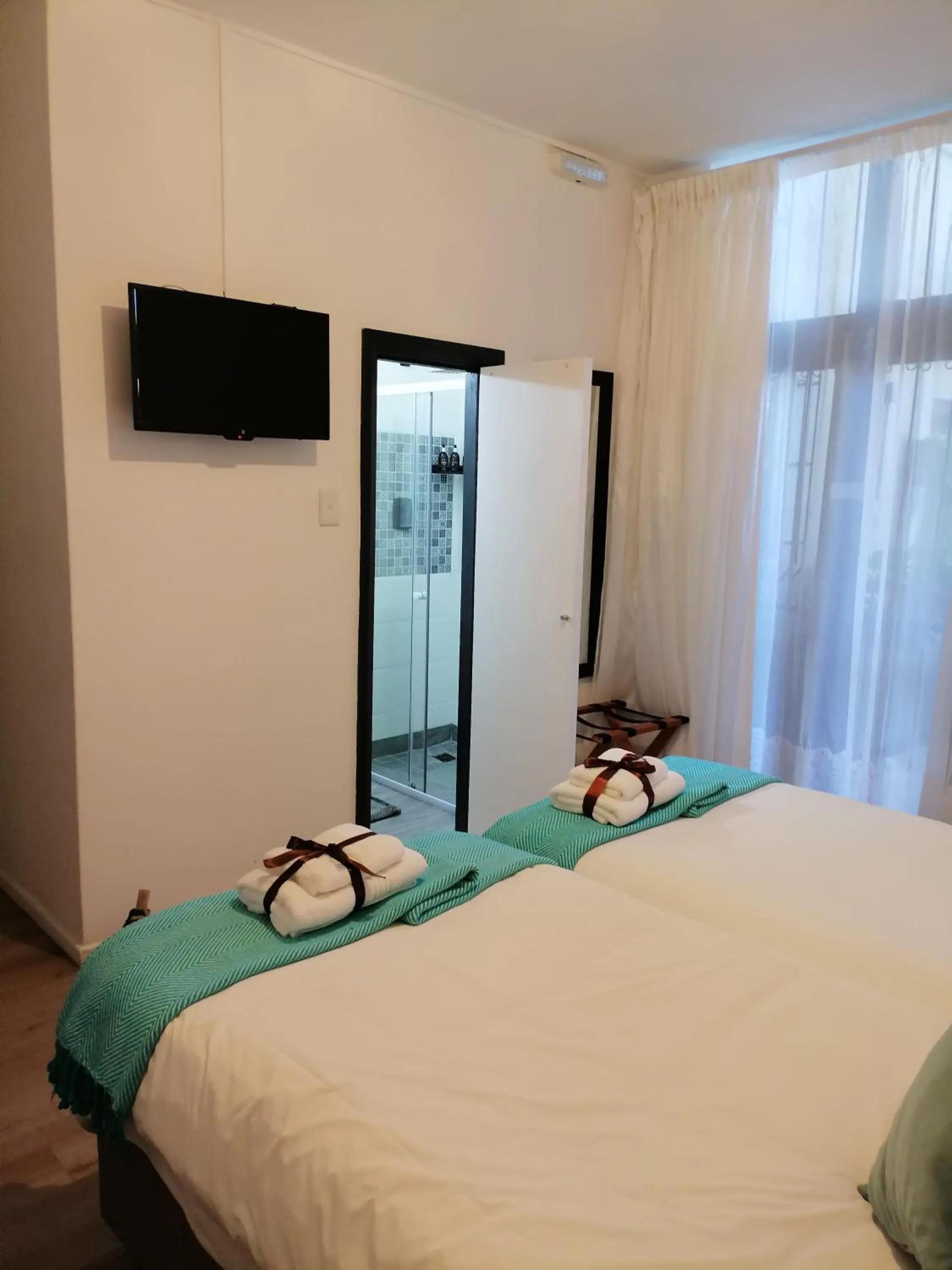 Bed in Point B Guest House -Sustainable Solar Energy