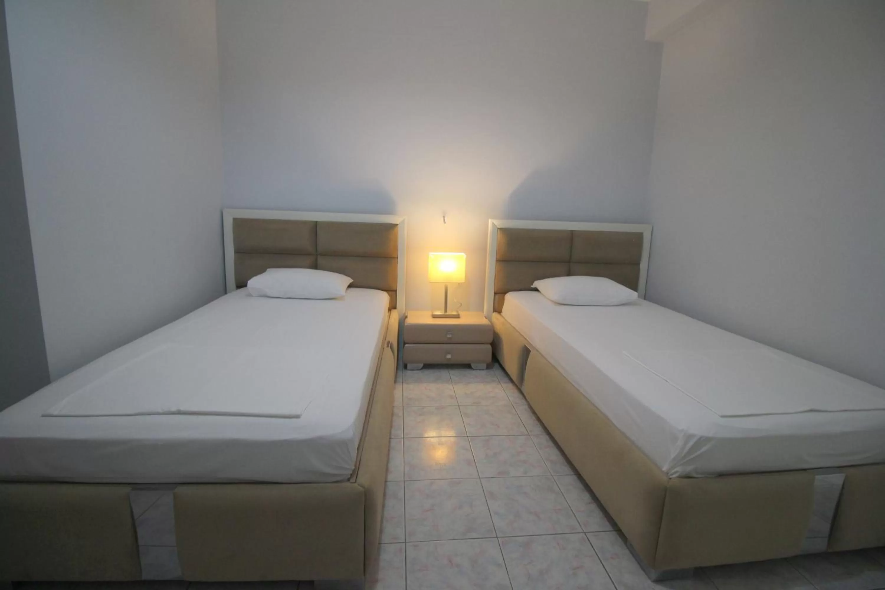 Bed in Murati Suites Sarandë