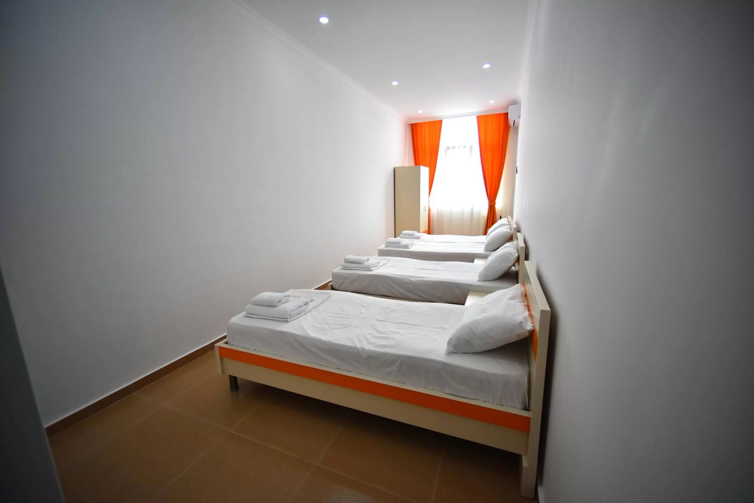 Bed in Orange Home Hotel