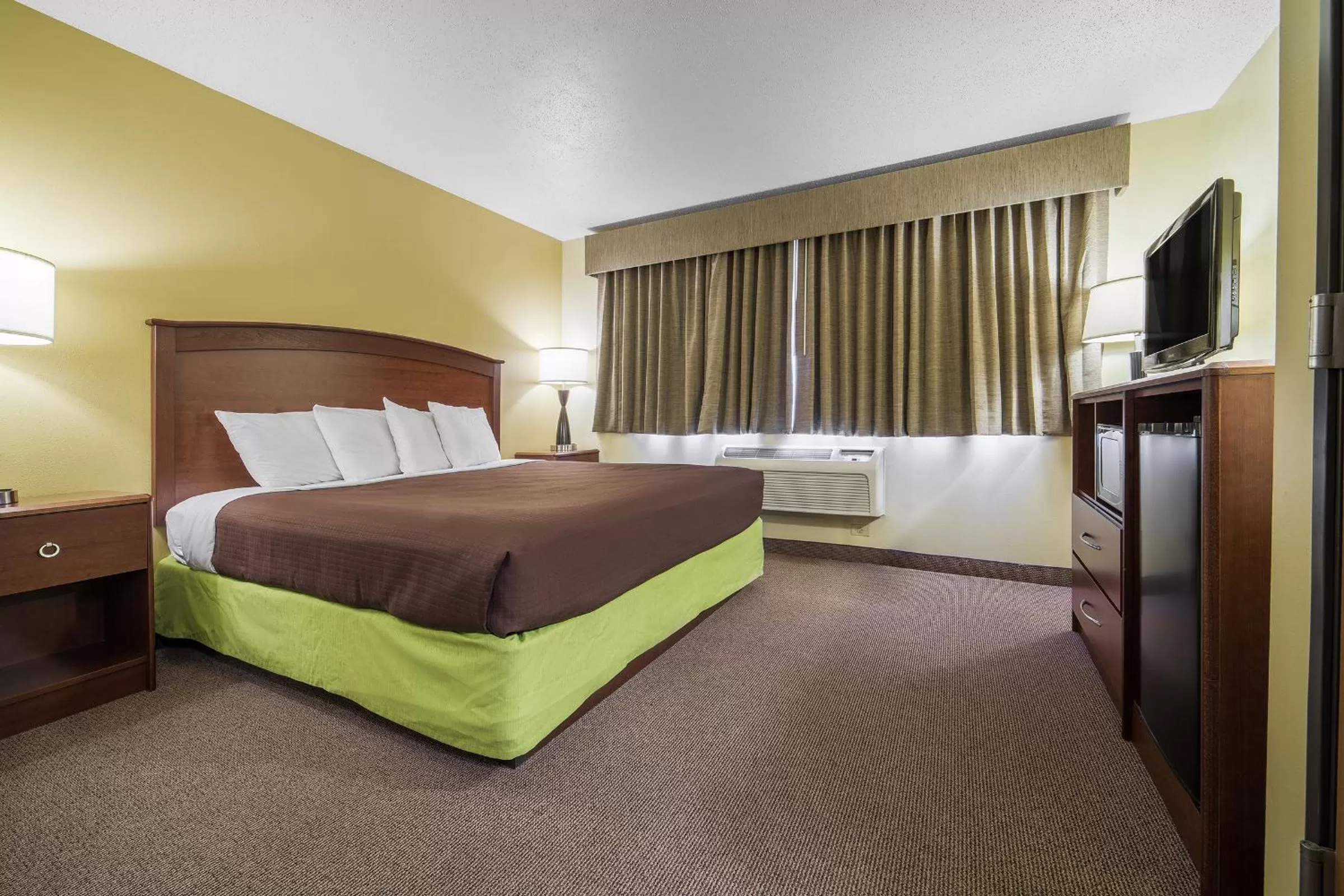 Bed in AmericInn by Wyndham Sioux Falls