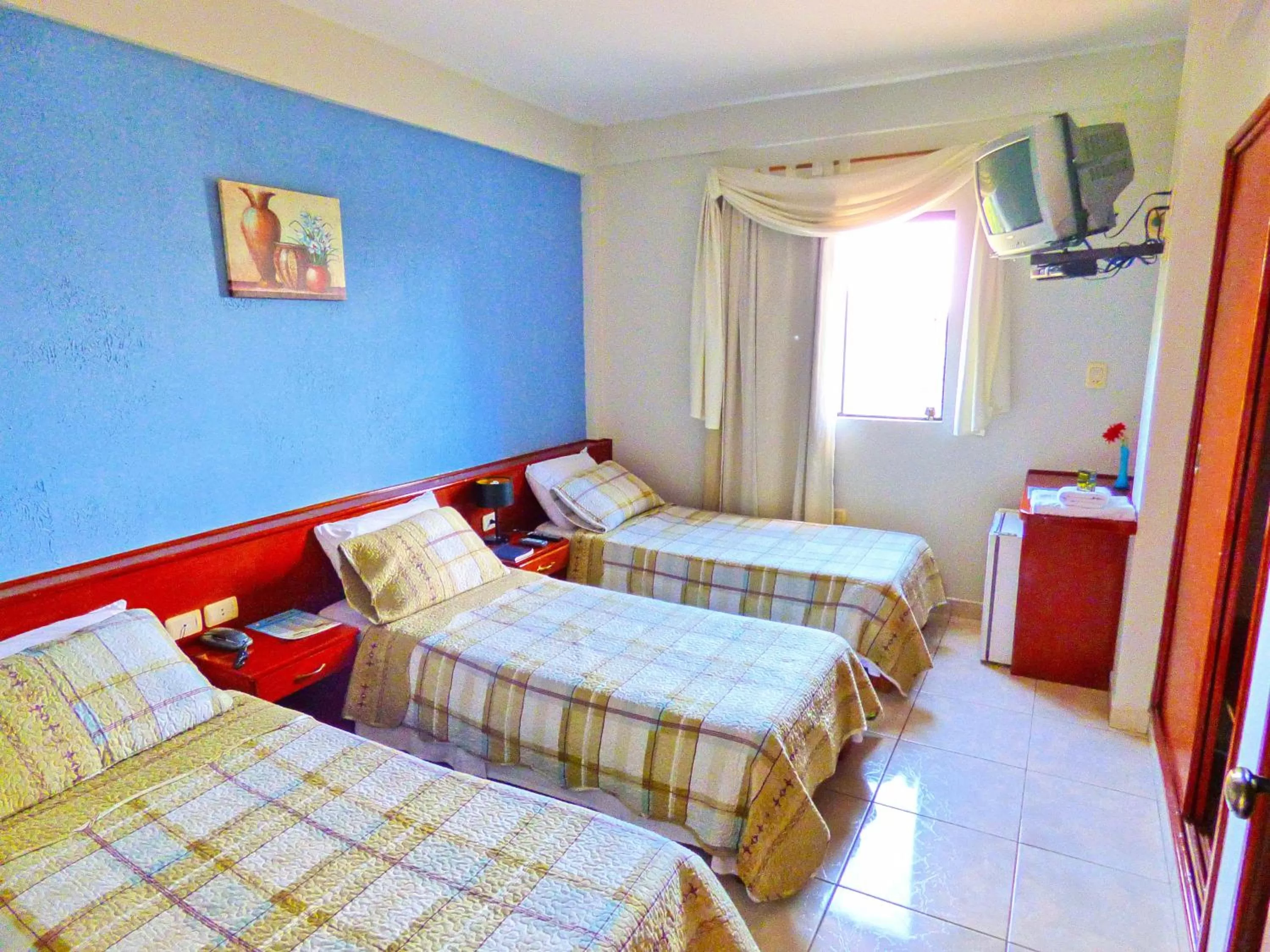 Bed in De La Costa Hotel