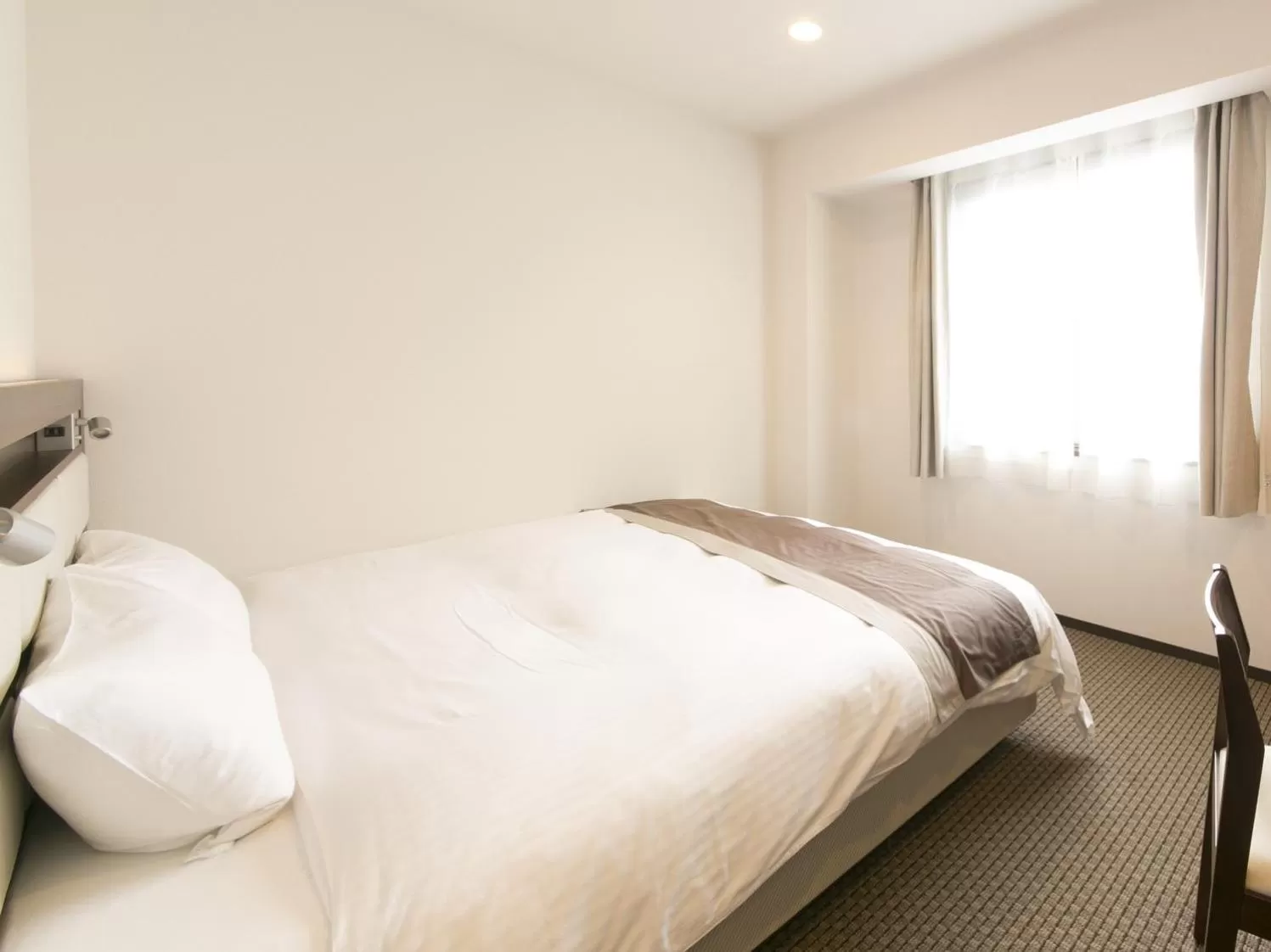 Bed in Urban Hotel Minami Kusatsu