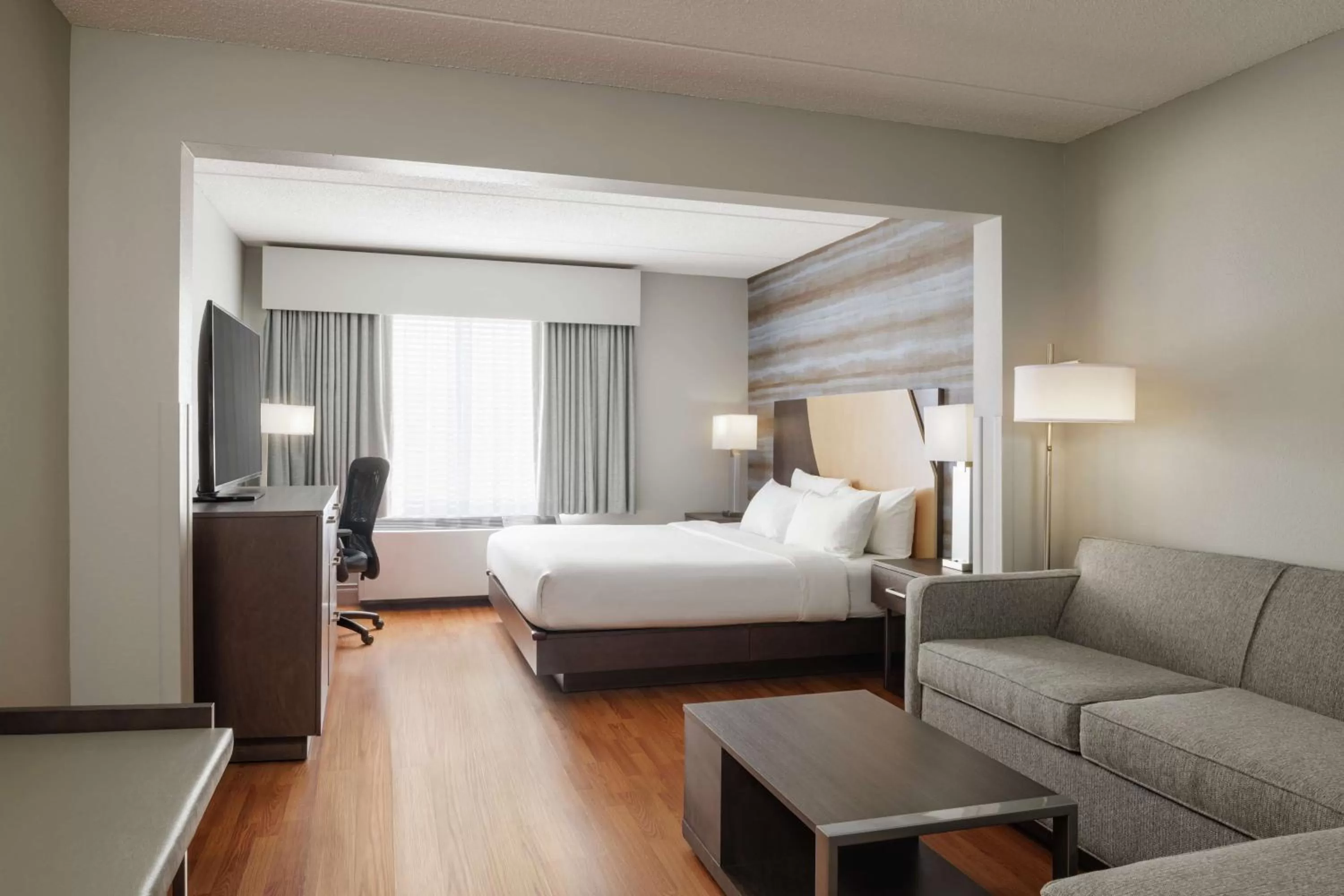 Living room, Bed in Hotel Trilogy Albany Airport, Tapestry Collection by Hilton