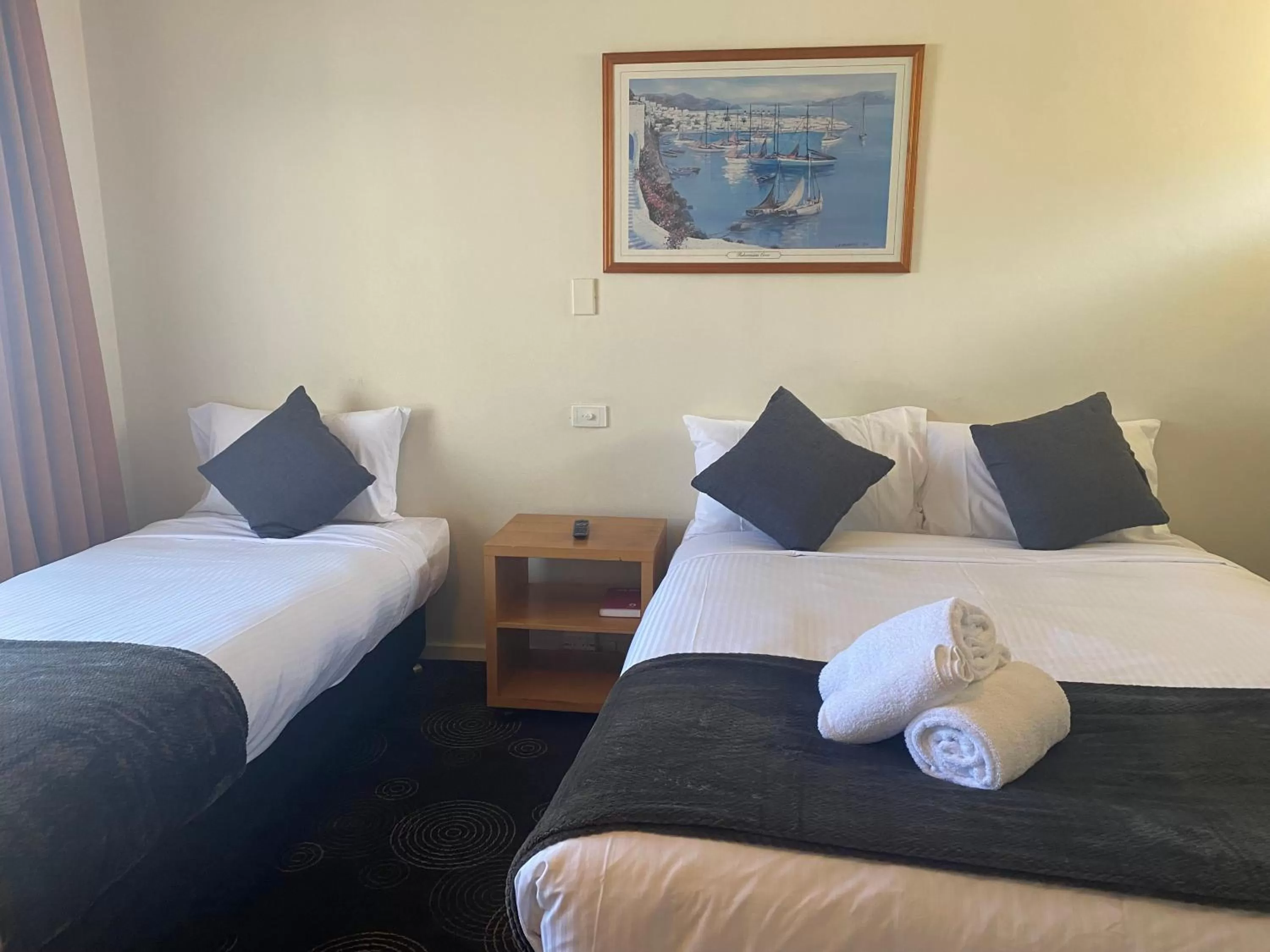 Bed in The Astor Hotel Motel