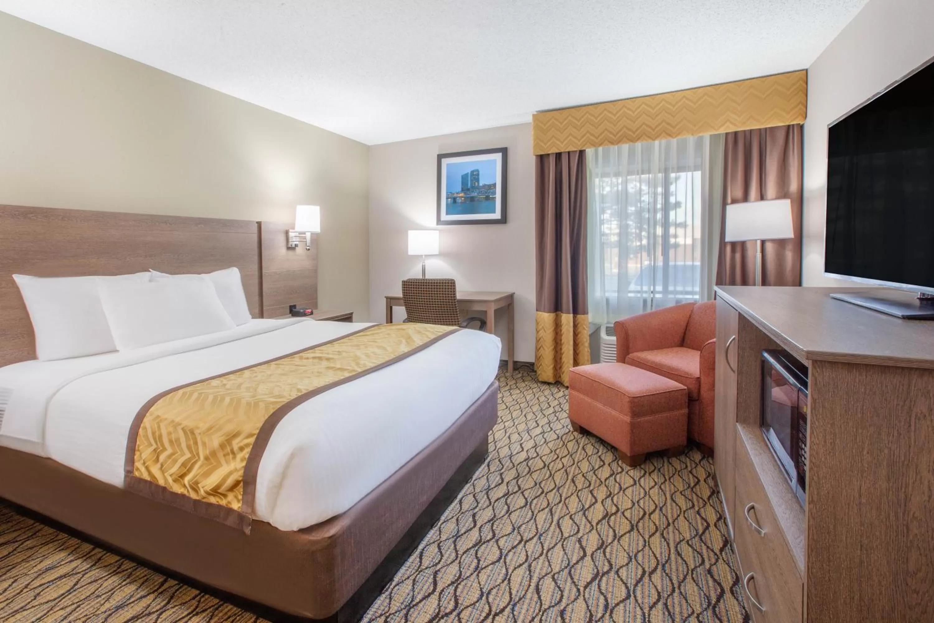 Bed in Baymont by Wyndham Grand Rapids Airport