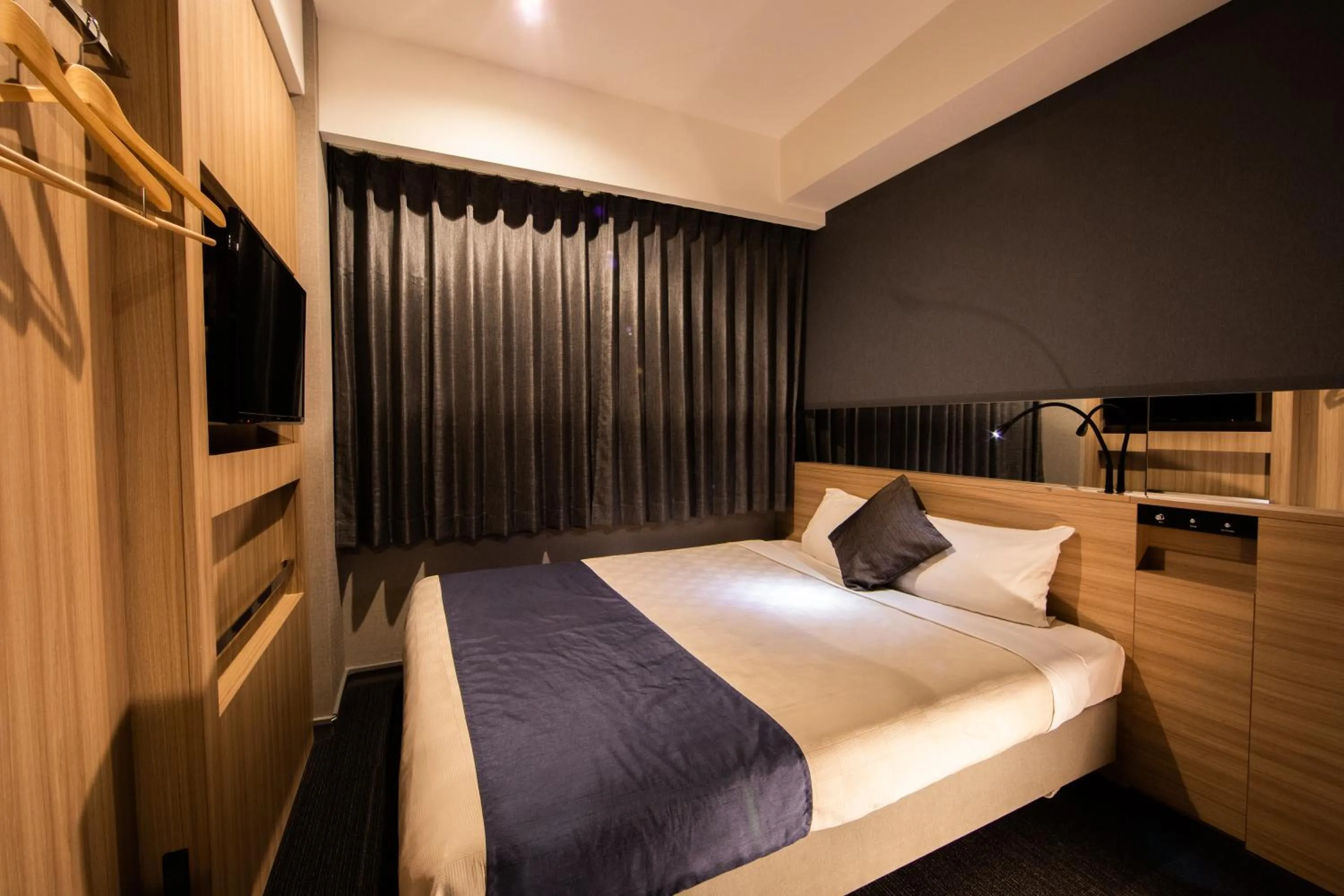 Photo of the whole room, Bed in Quintessa Hotel Osaka Shinsaibashi Comic & Books