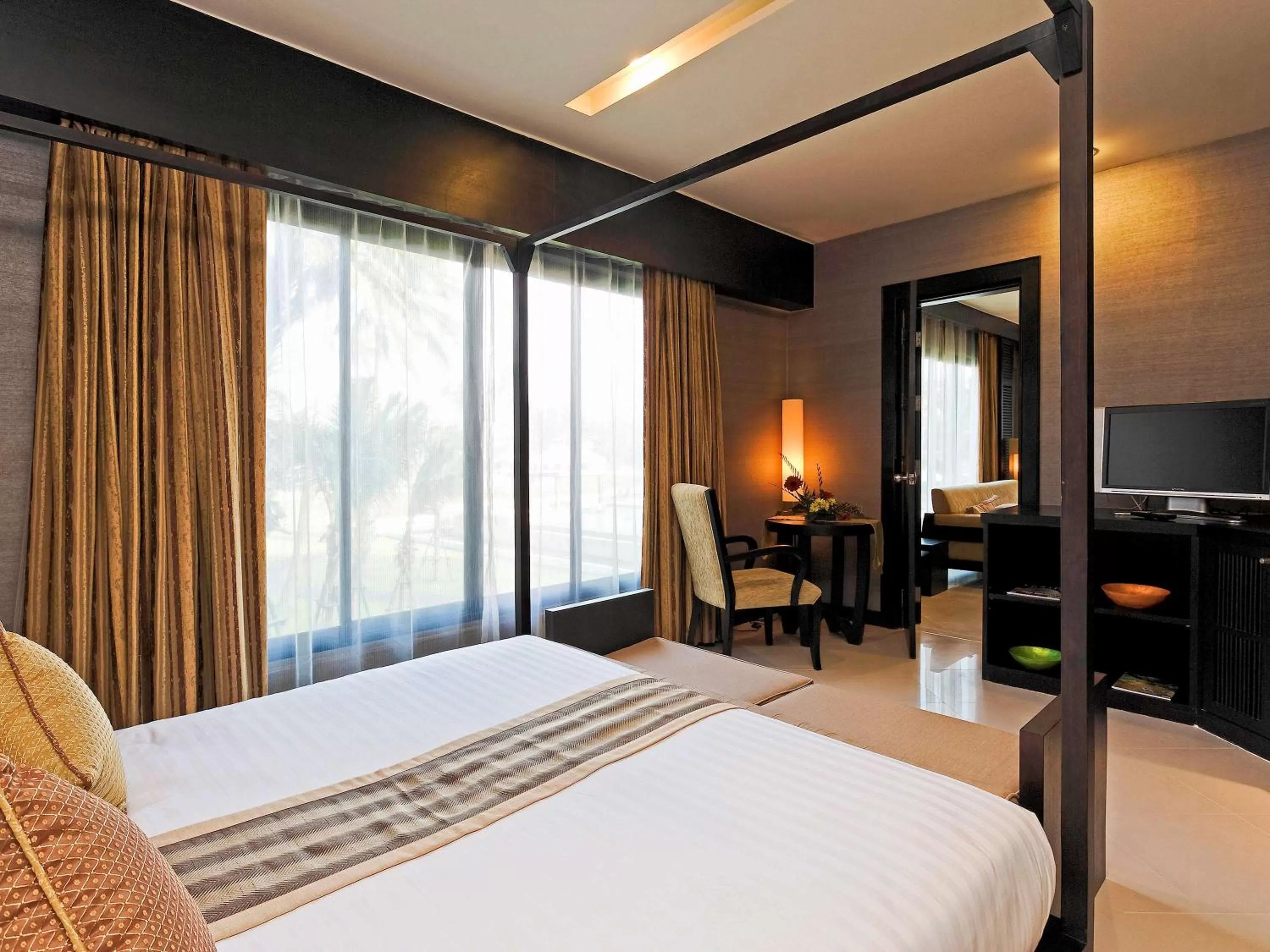 Photo of the whole room, Bed in The Nouveau Chumphon Beach Resort And Golf