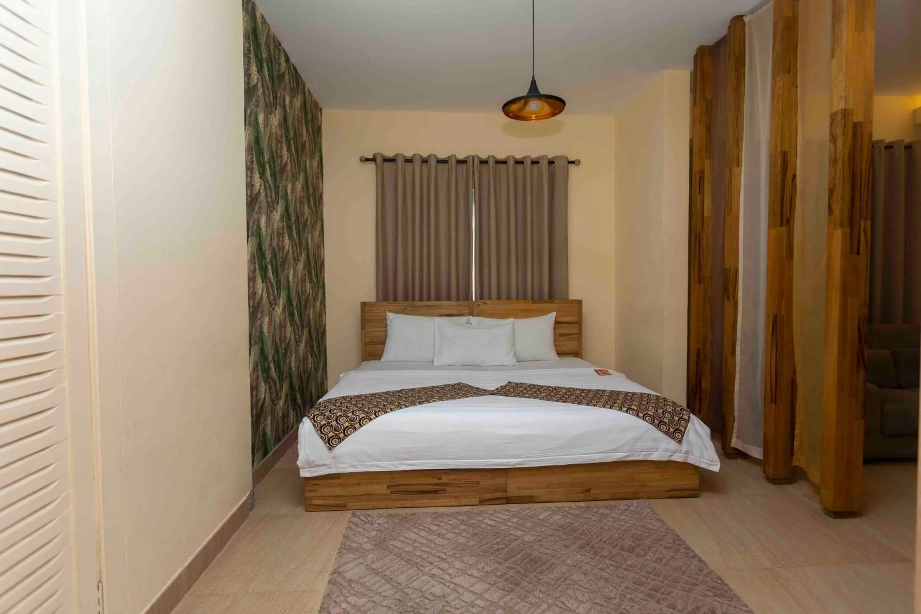 Bed in Roots Hotel Apartment