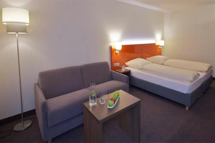 Photo of the whole room, Bed in iQ-Hotel Ulm