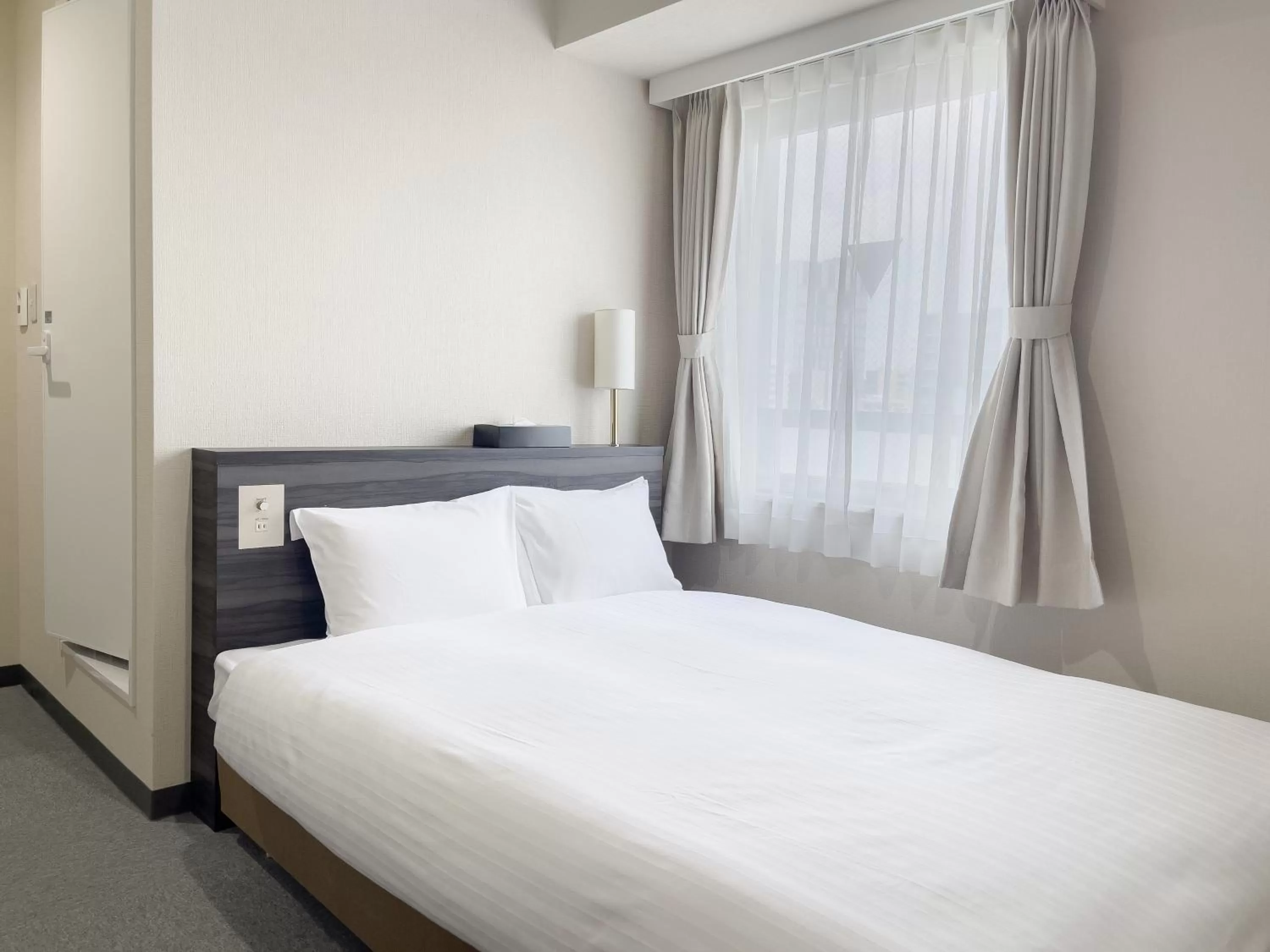 Bed in CHECKinn Osaka Shinimamiya