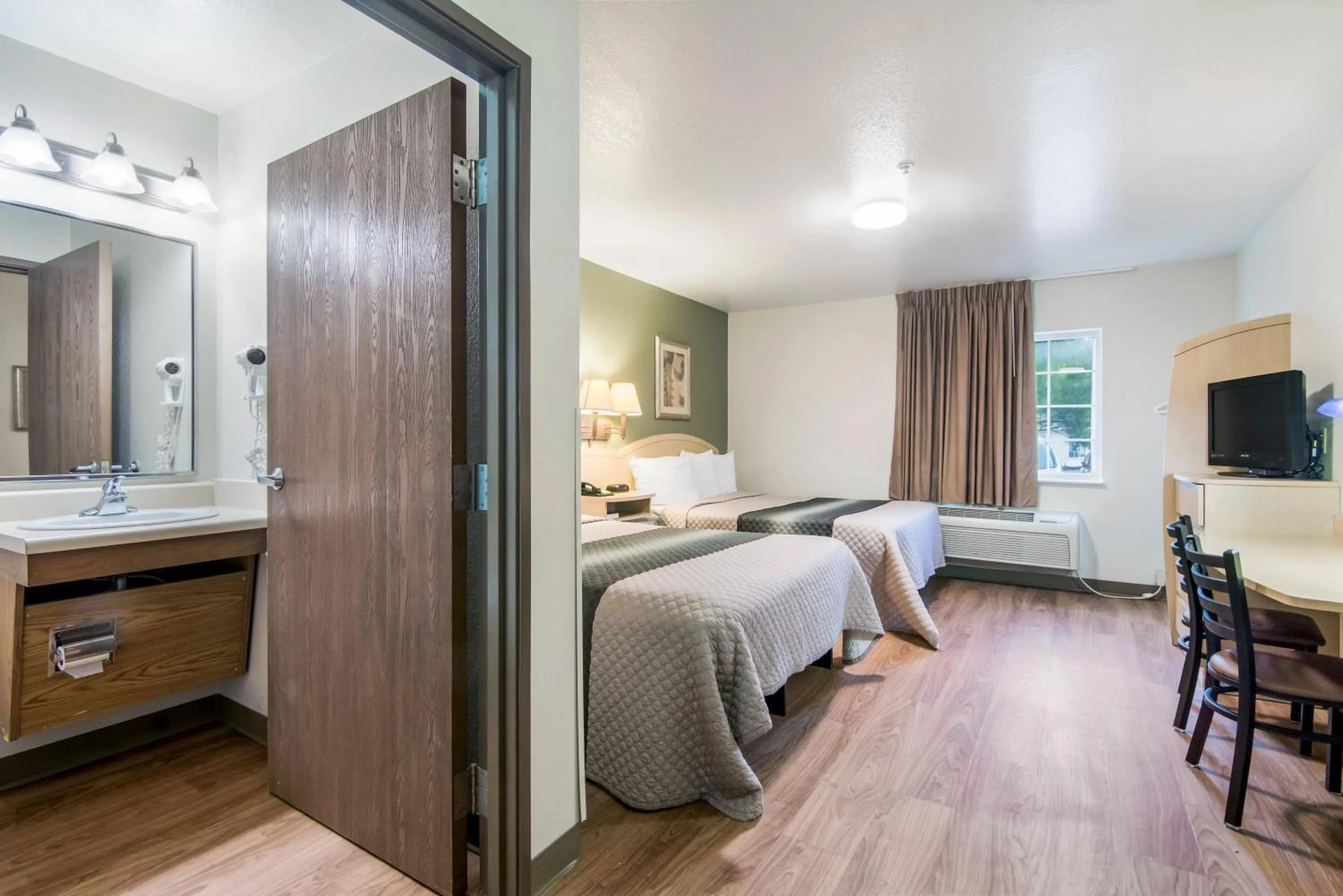 Photo of the whole room, Bed in HomeTowne Studios & Suites by Red Roof Bentonville