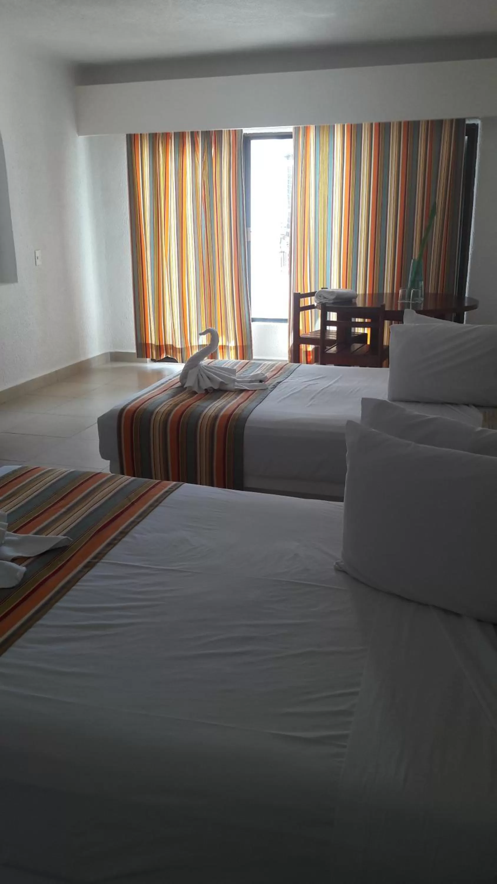 Bedroom, Bed in Pelicano Inn Playa del Carmen - Beachfront Hotel